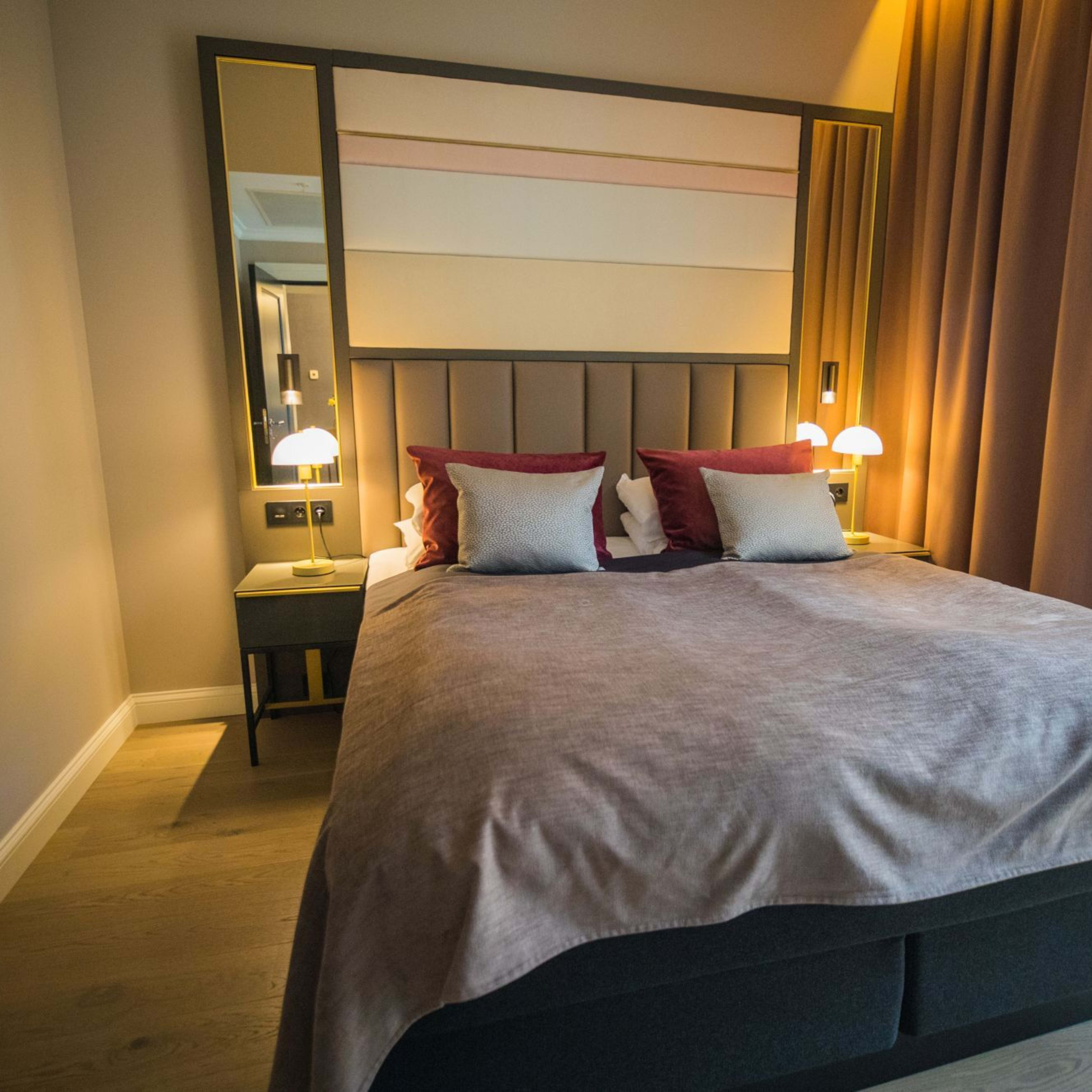 Elegant double room at Opus XVI Hotel with autumn colored interior and city view, centrally located in Bergen