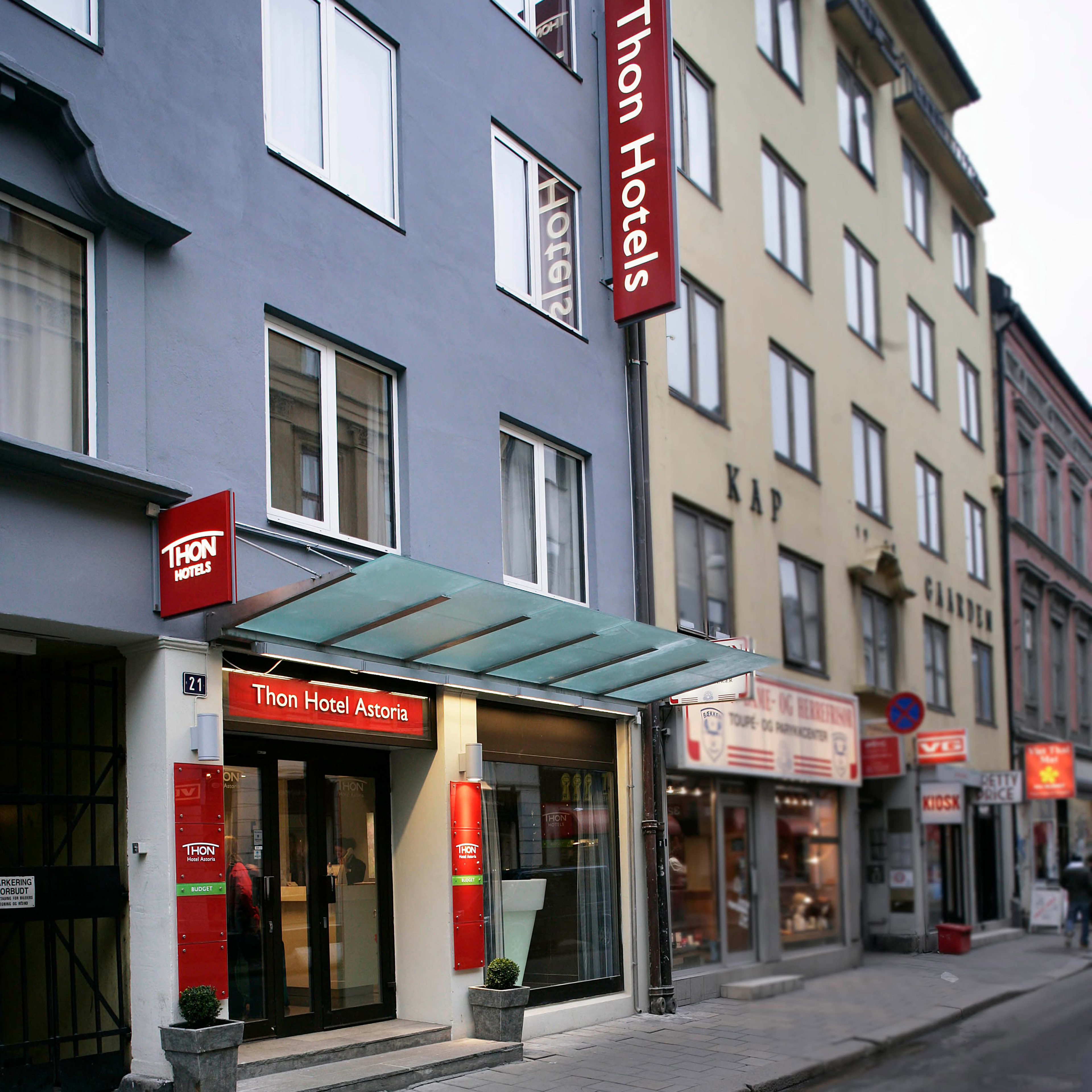 Thon Hotel Astoria Oslo facade with red hotel sign and street entrance in city center