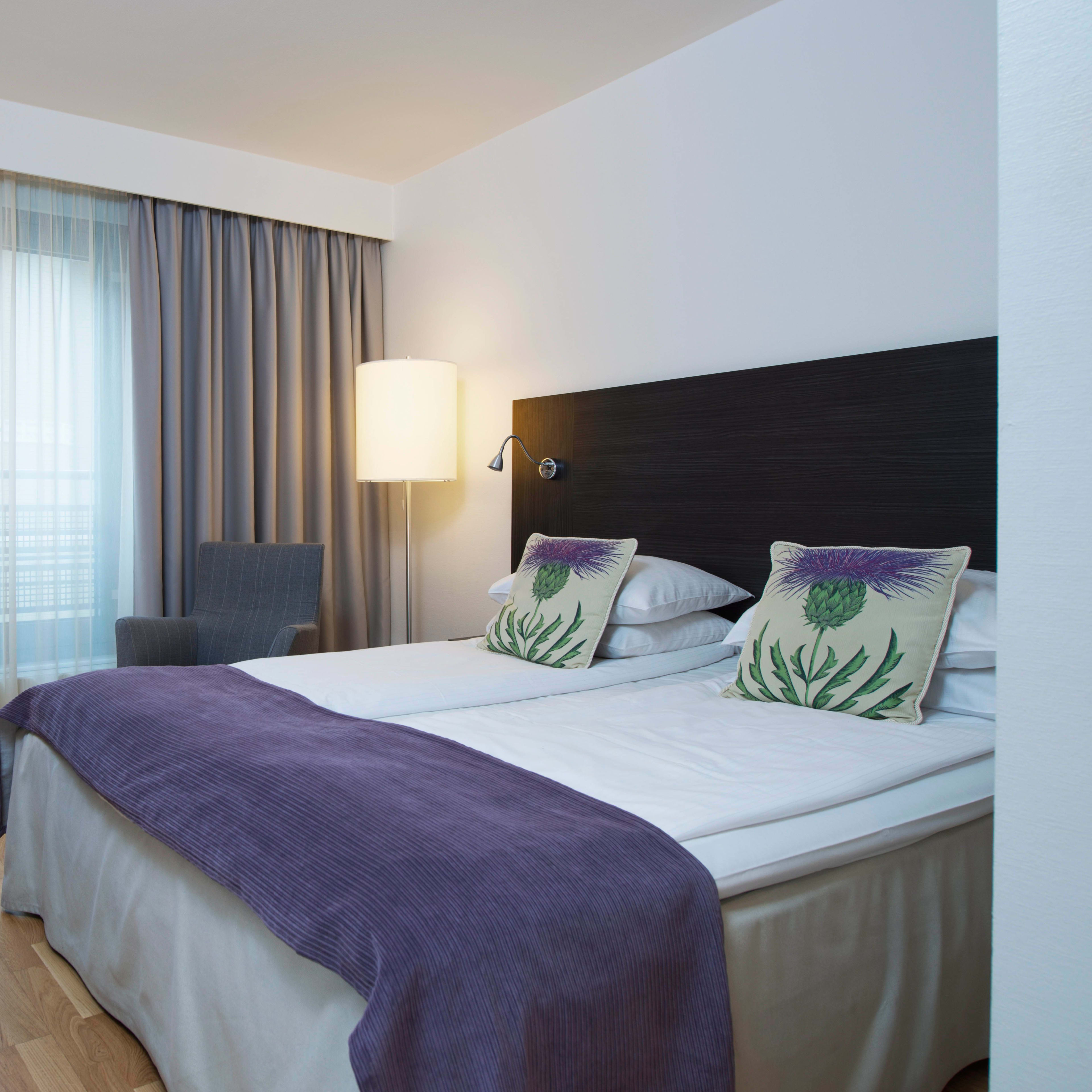 Elegant double room at Thon Hotel Cecil Oslo with comfortable bed and stunning city views