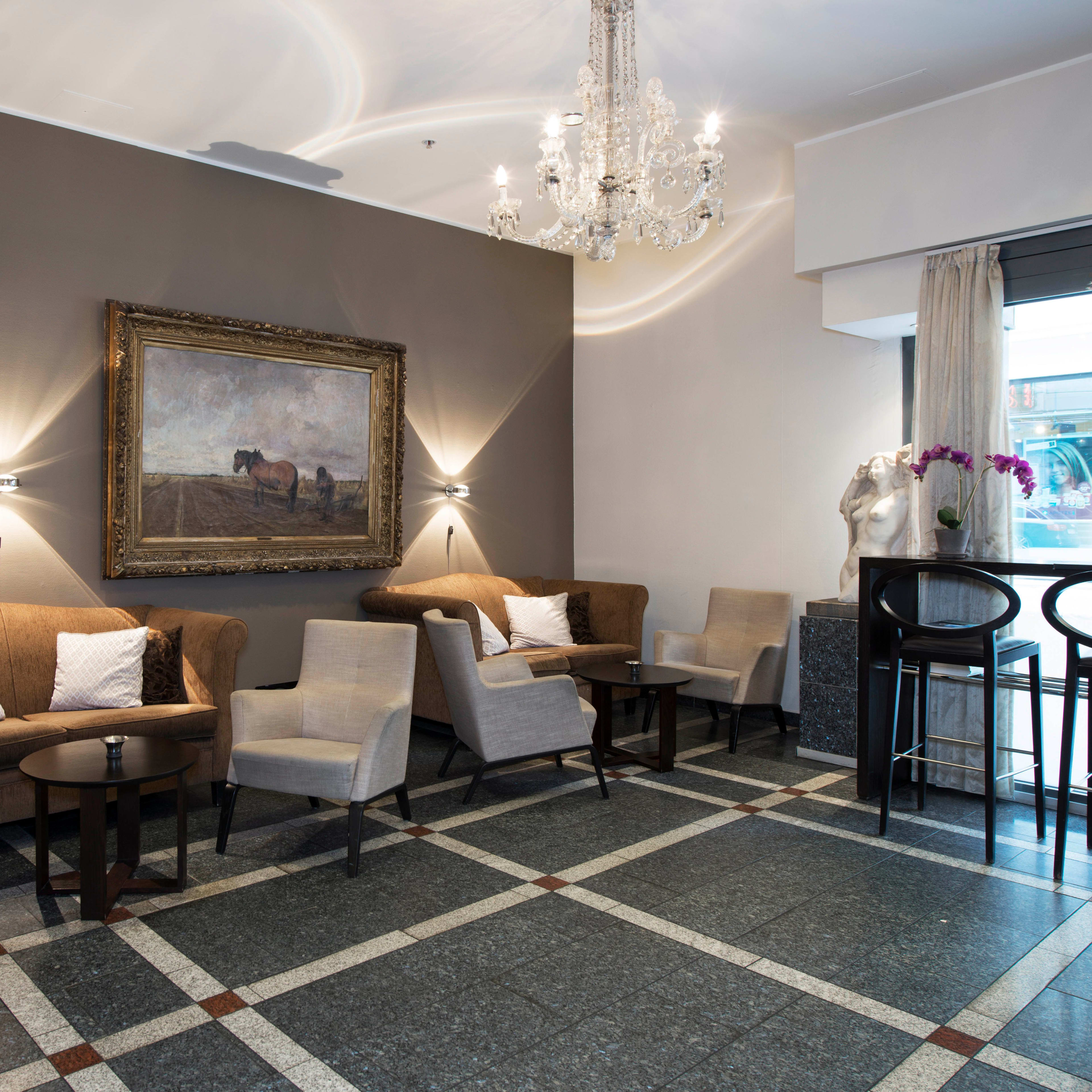 Inviting hotel lobby Thon Cecil Oslo featuring comfortable furniture and elegant lighting