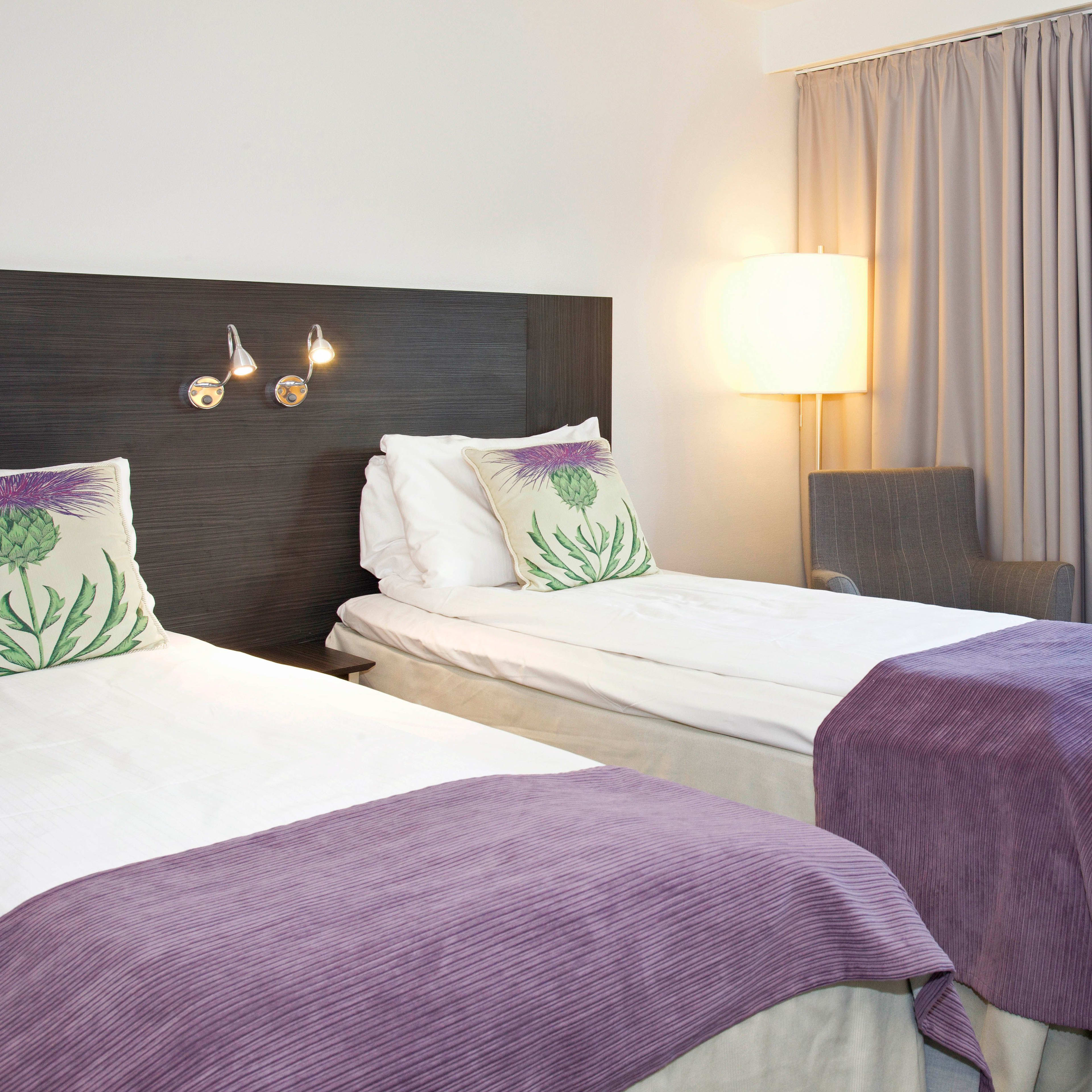 Modern double room at Thon Hotel Cecil Oslo with twin beds and purple interior design