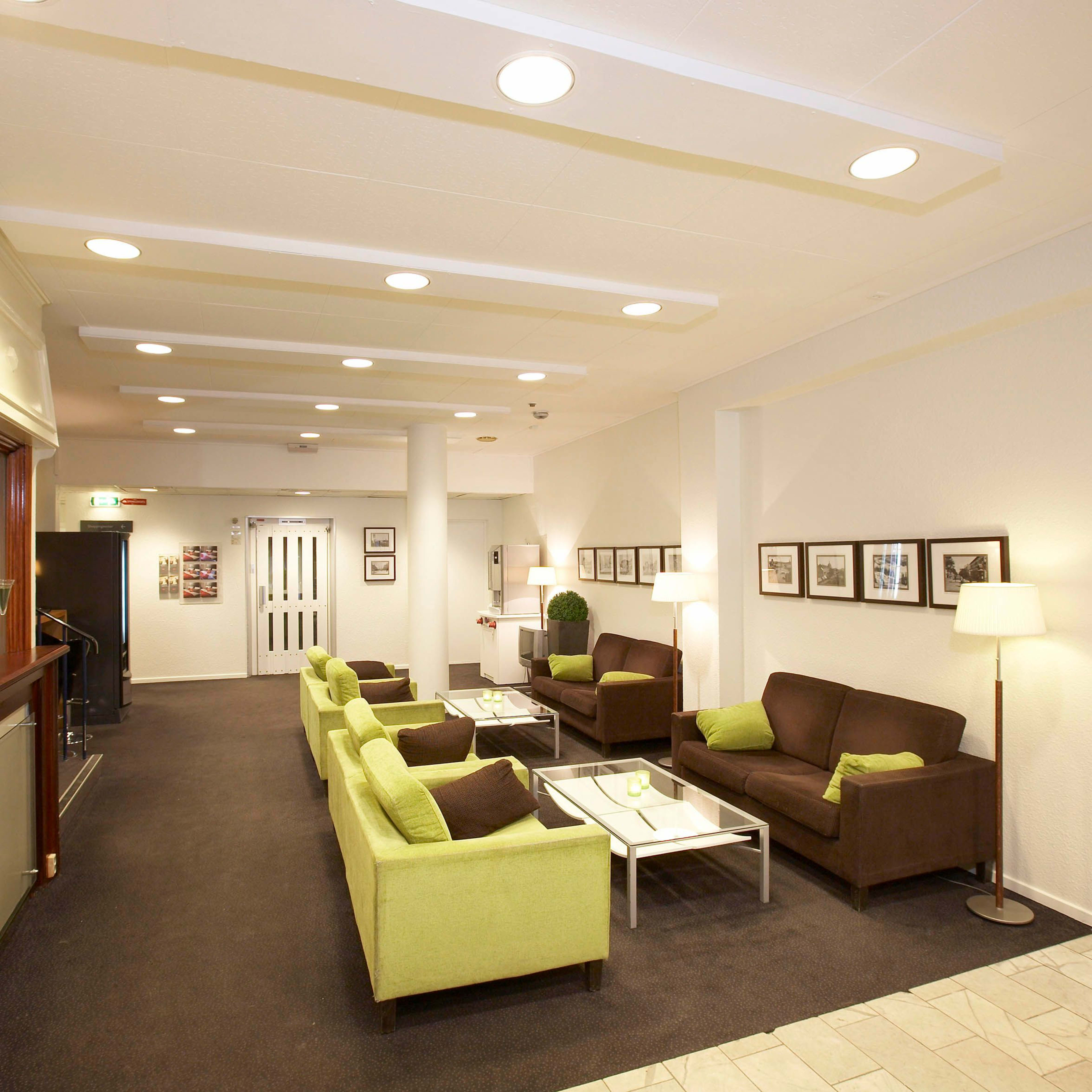 Thon Hotel Trondheim Lobby - SEO Alt-Text Options English Versions SEO-Optimized Primary Alt-text: "Modern lobby at Thon Hotel Trondheim with comfortable green sofas and stylish brown interior desi