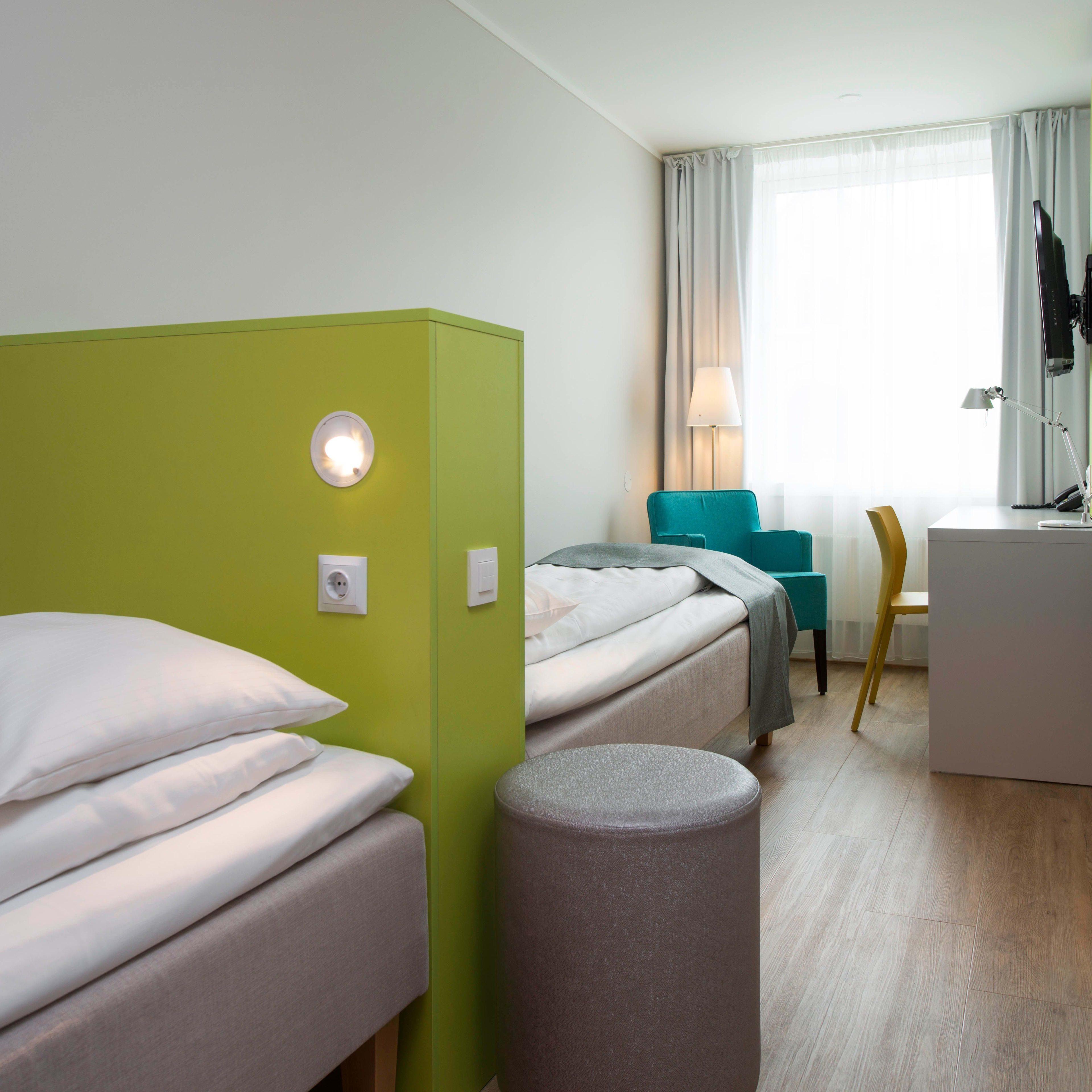 Comfortable double room at Thon Hotel Trondheim with green grey decor and twin beds Norway