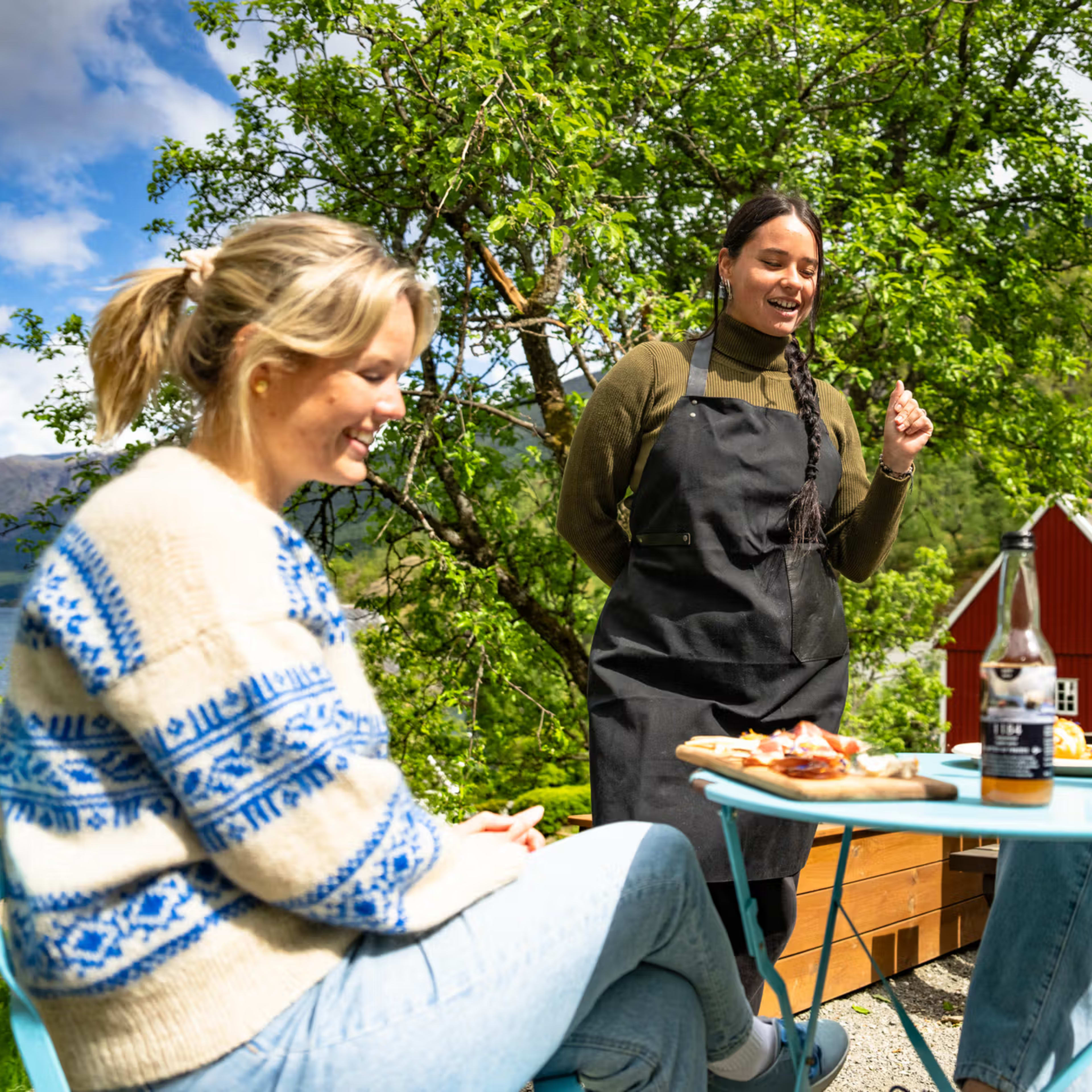 Traditional Norwegian three-course farm lunch served outdoors at Flåm fjord farm