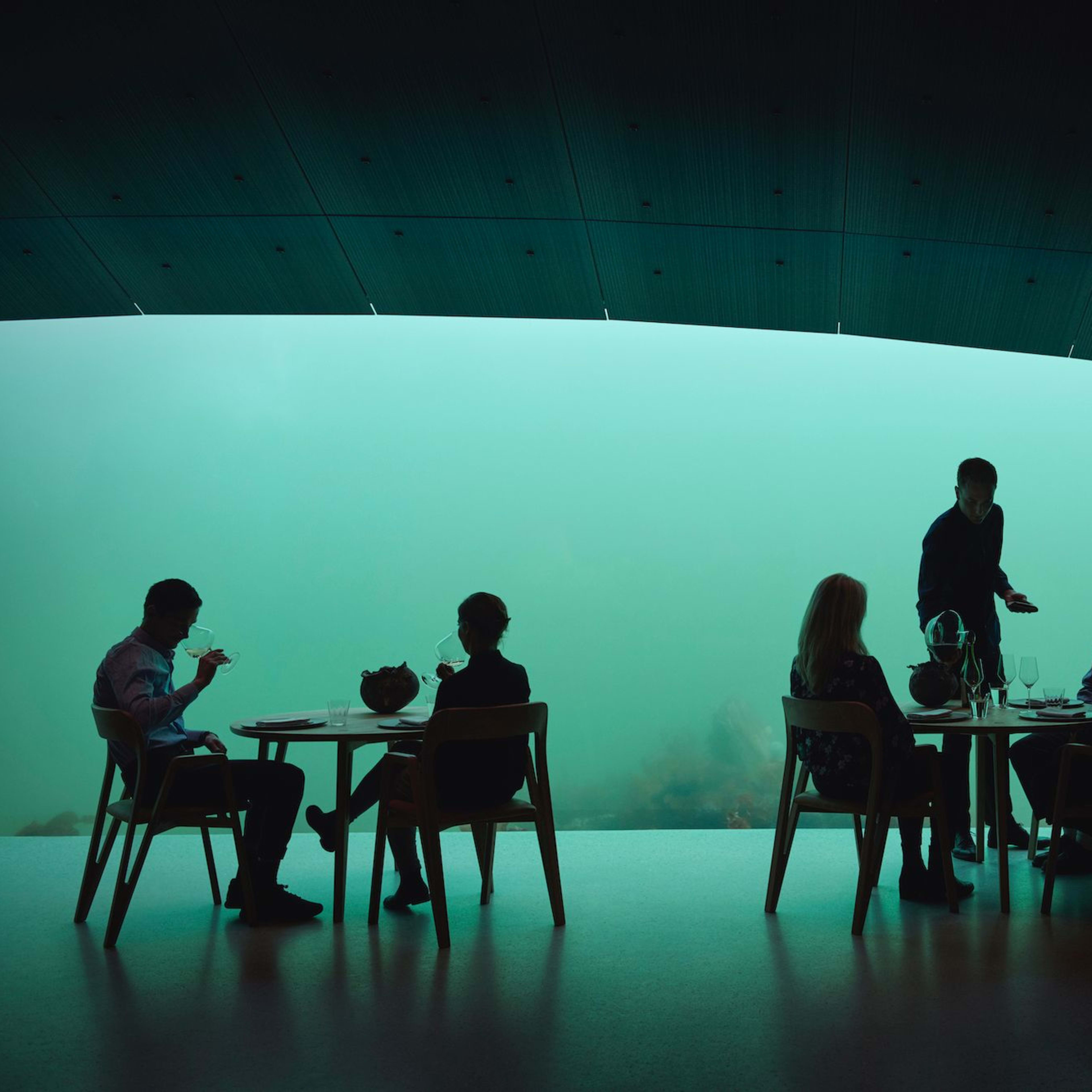 Guests enjoying a delicious meal in an underwater  restaurant in Southern Norway