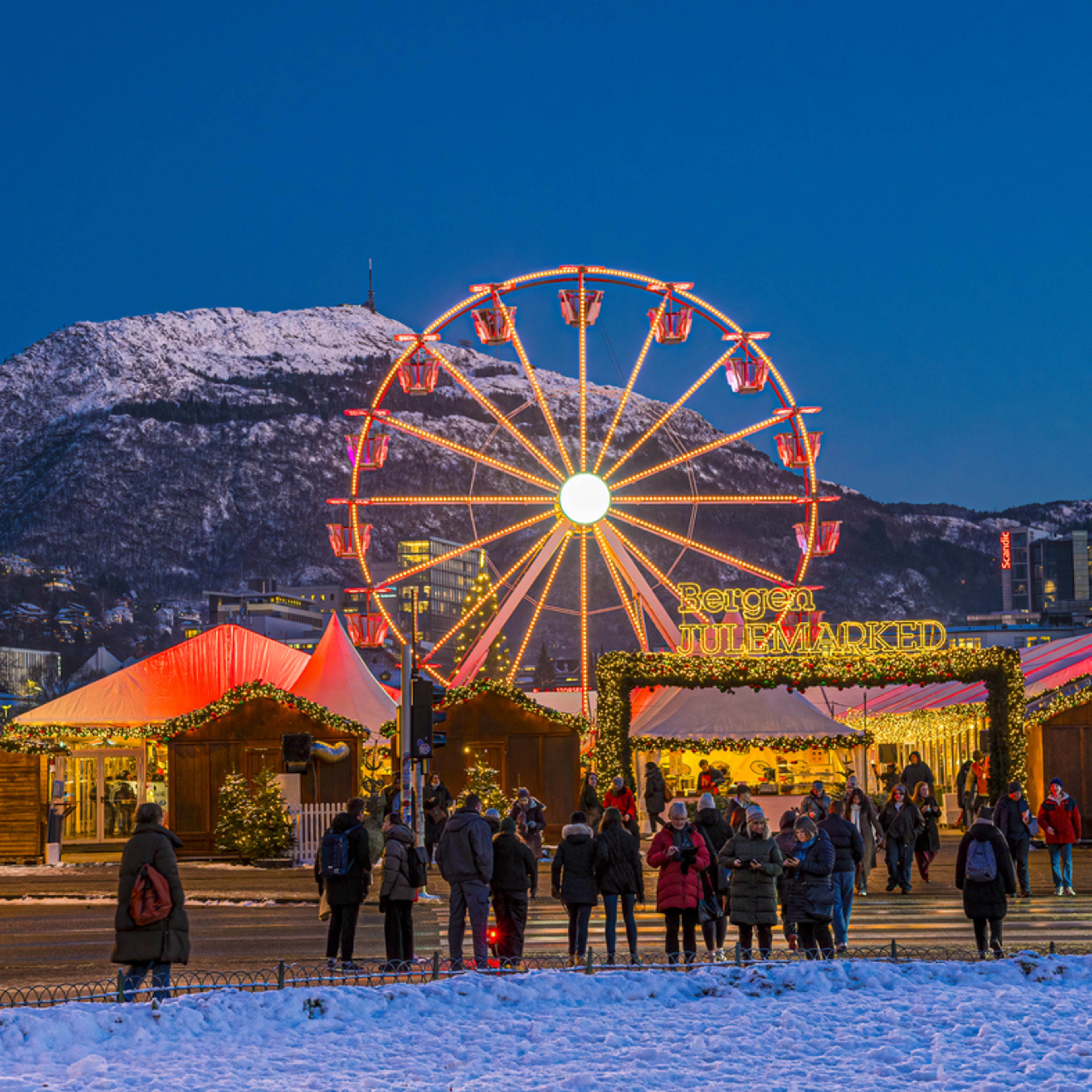 Bergen Christmas market at Festplassen with illuminated Ferris wheel at dusk