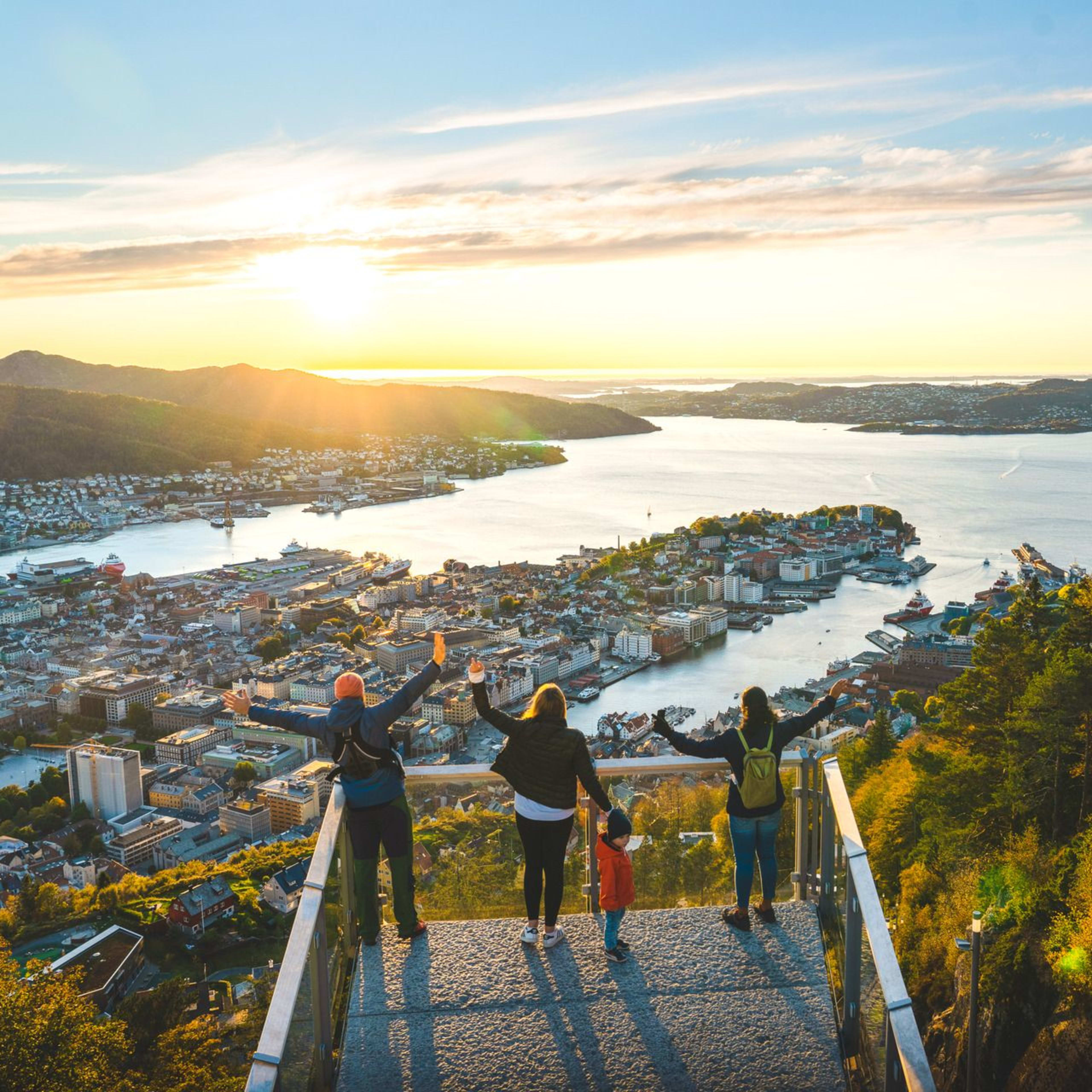Visitors at Mount Fløyen viewpoint enjoying panoramic views of Bergen city, fjords and surrounding mountains