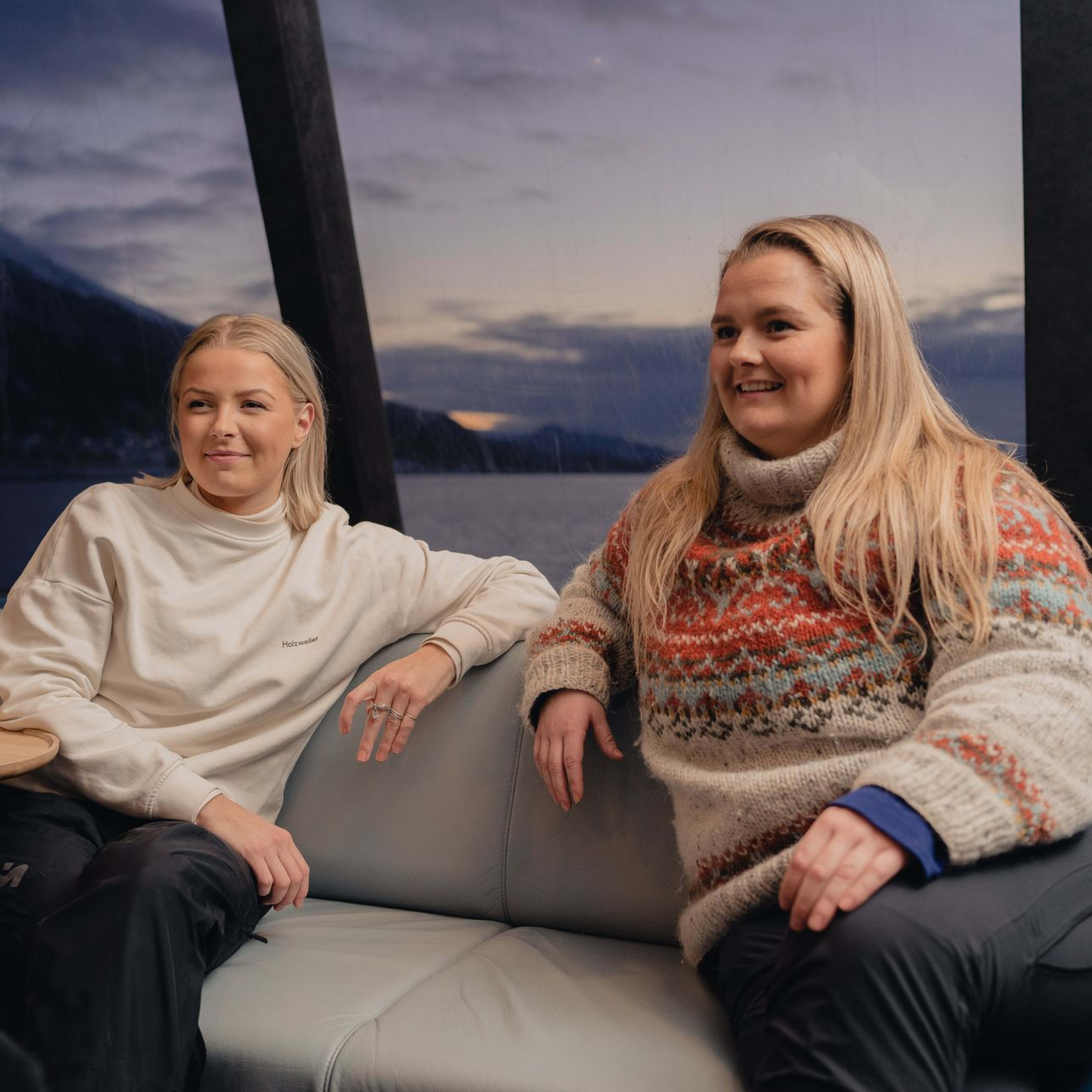 Two women enjoying the arctic fjord view from the fjord cruise in Tromsø.