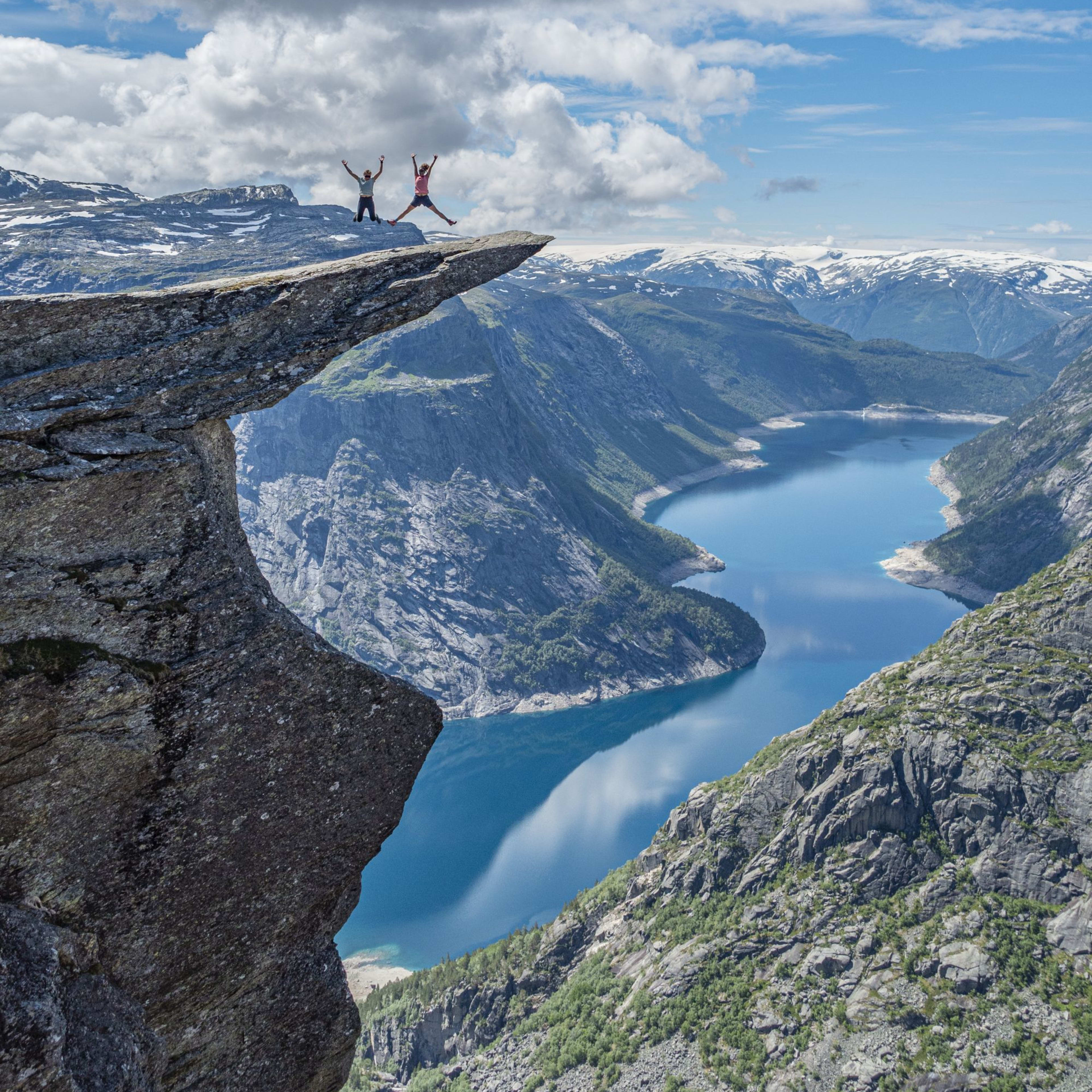 Jumping high on Trolltunga after hiking the classic route to the top