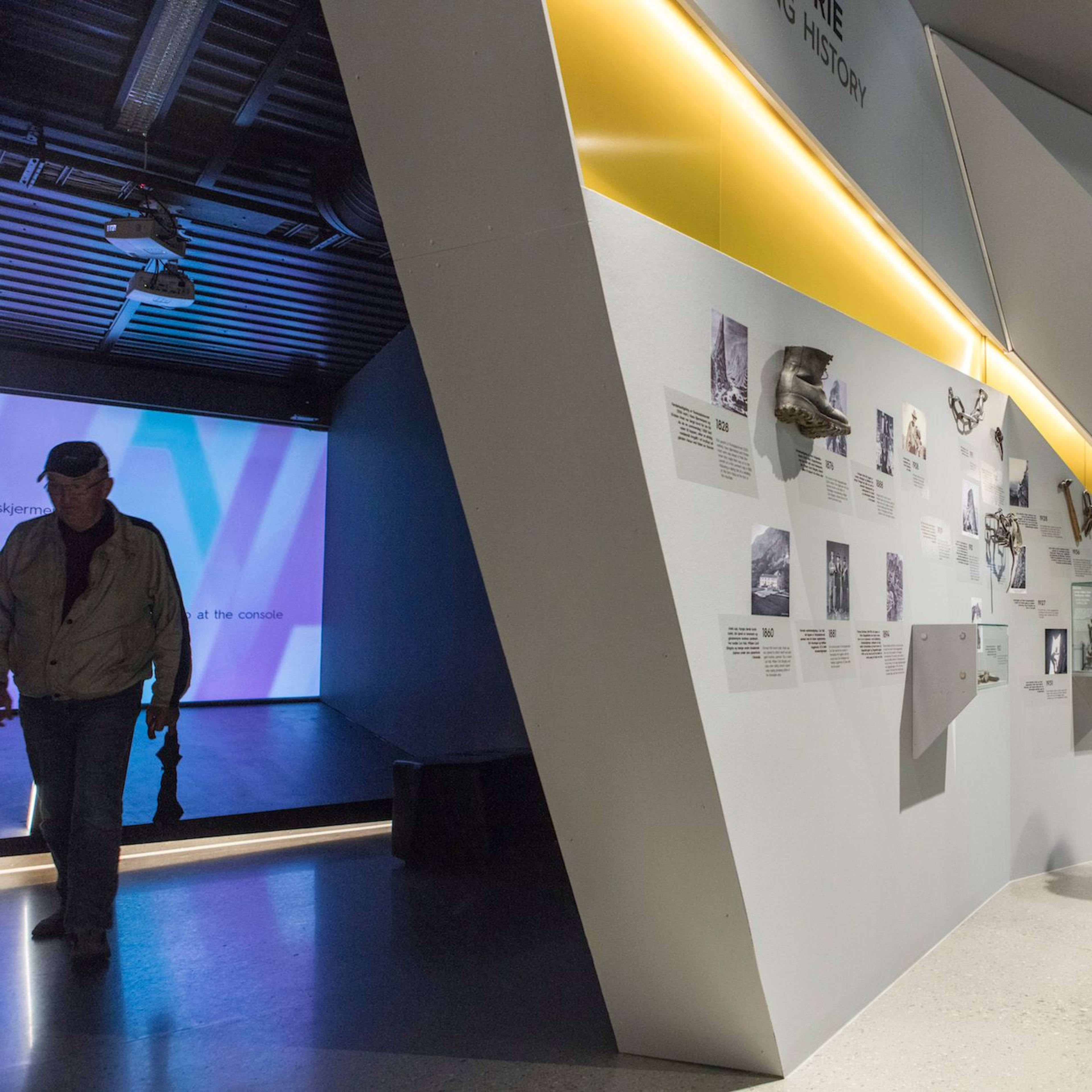 An exhibit space with historical climbing displays, including photographs and objects related to climbing history.