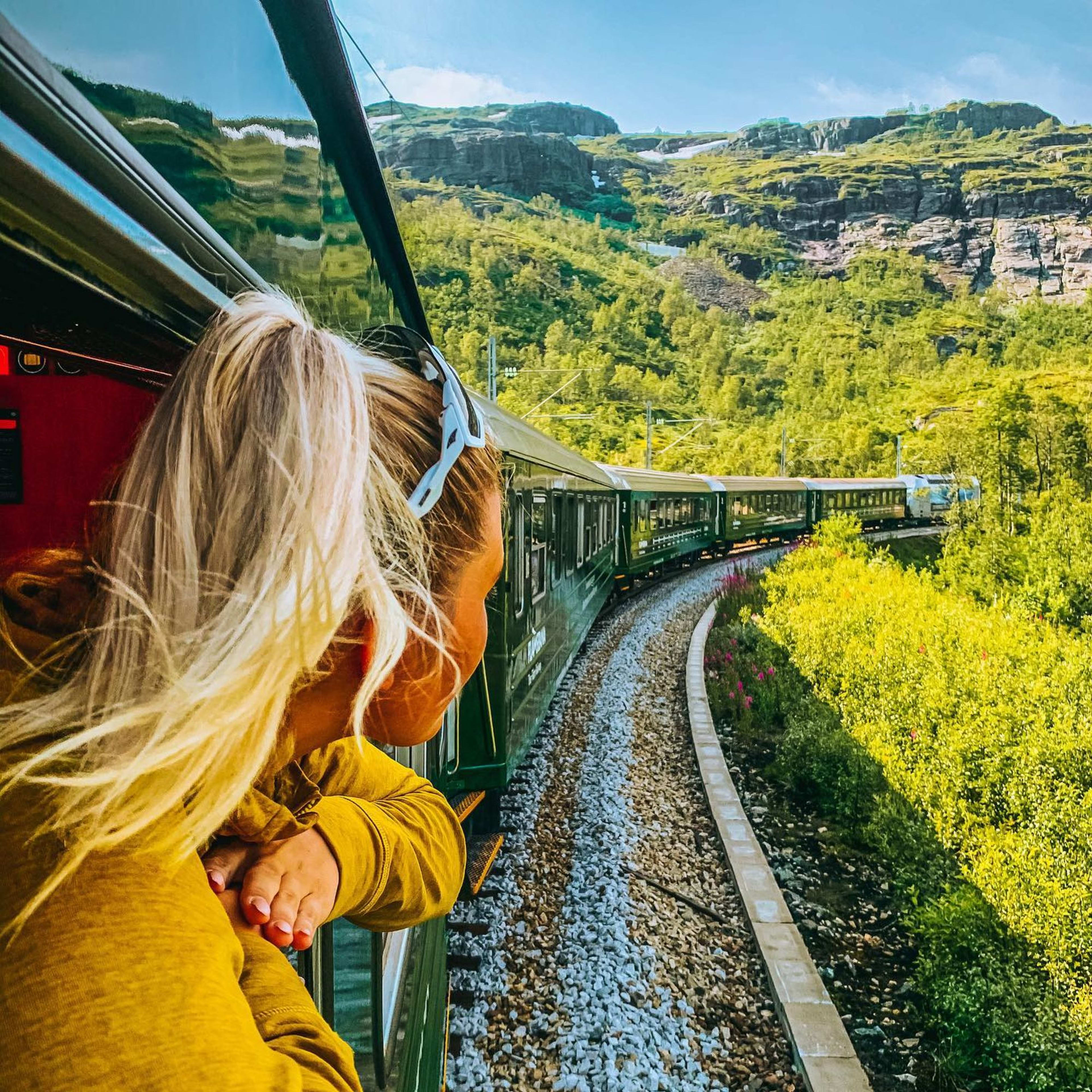 Girl enjoying the view of UNESCO landscape on the Flåm railway between Myrdal and Flåm