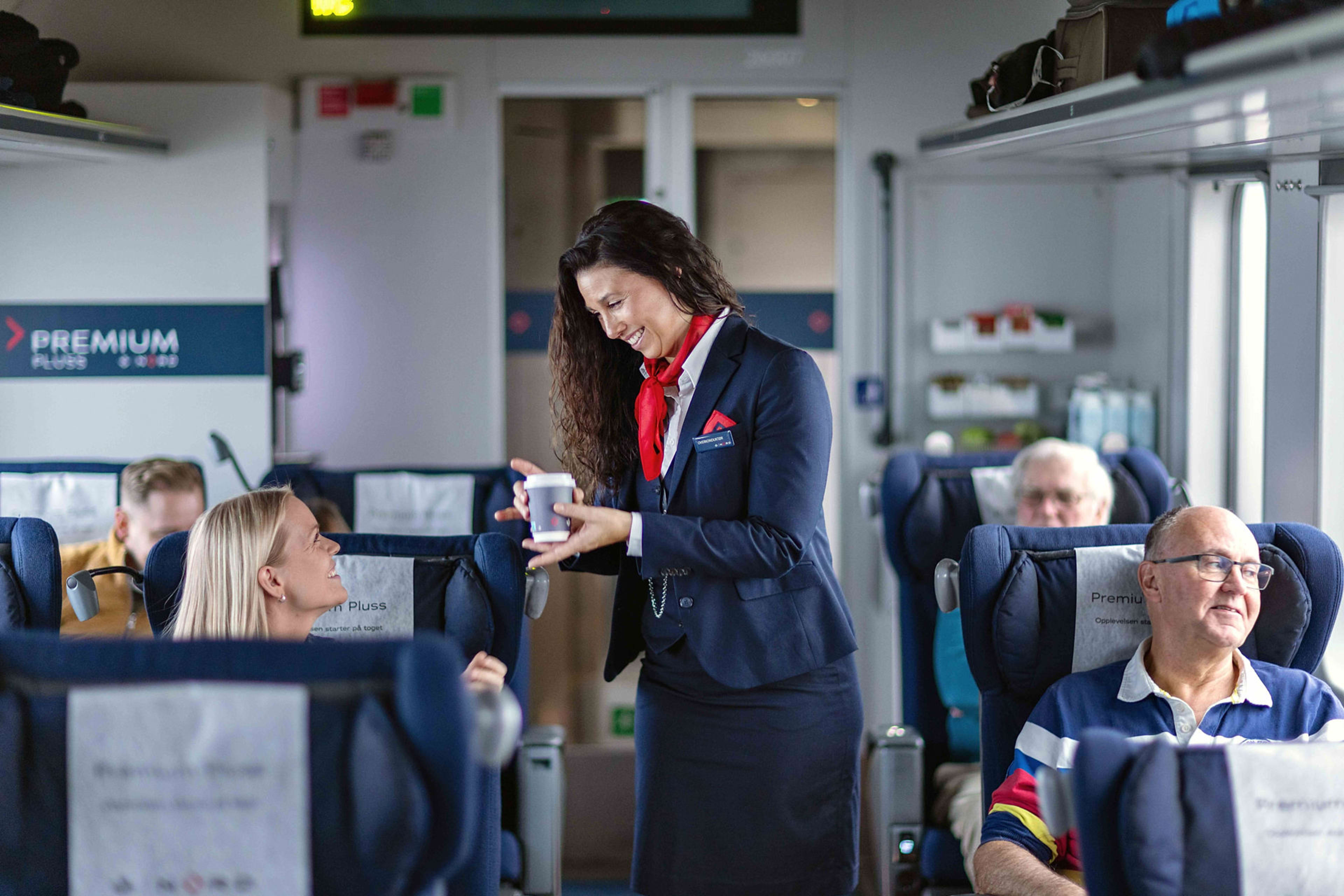 Woman serving passengers coffee on train