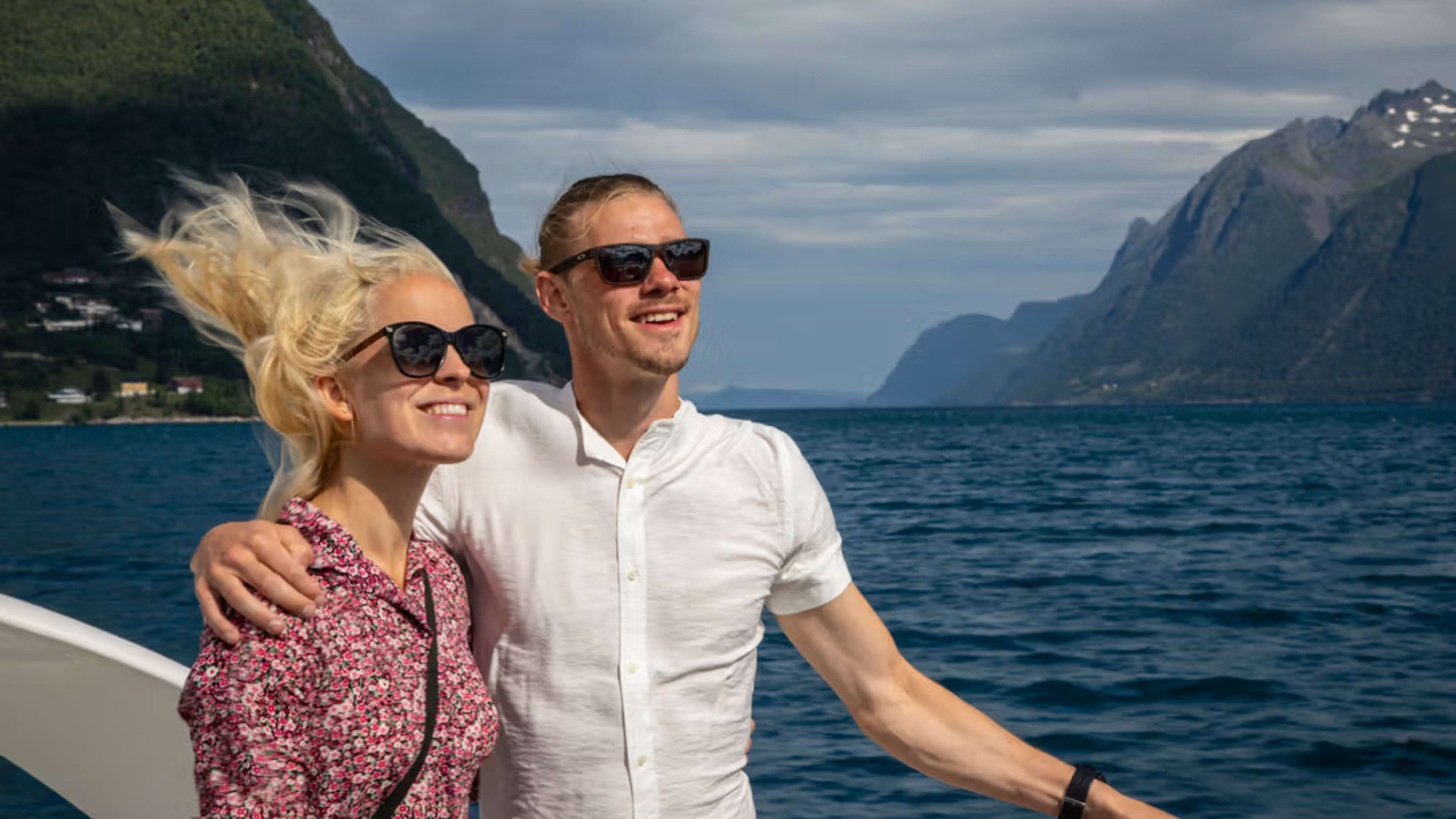 Couple enjoying romantic moment during Norwegian fjord cruise