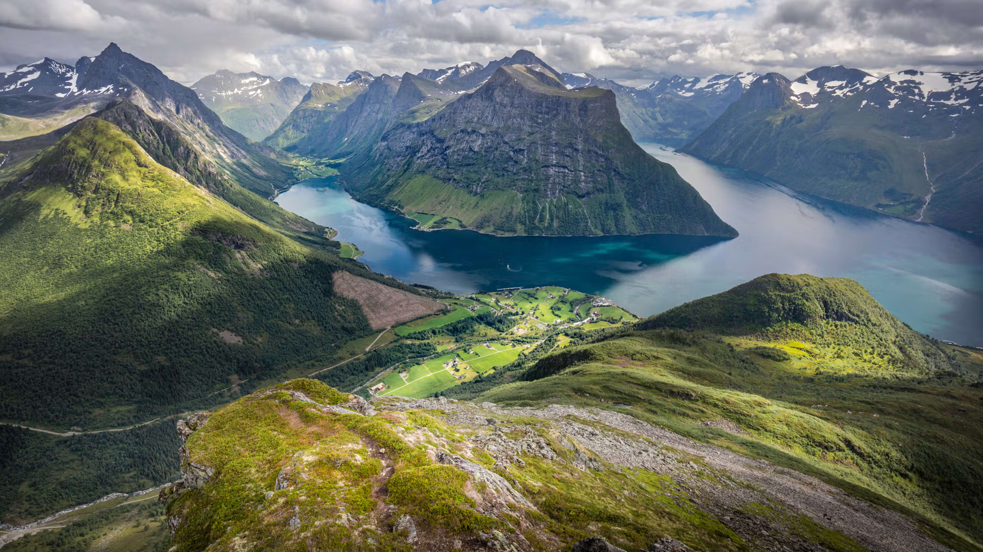 Aerial view of dramatic Hjørundfjord with steep mountains and green valleys
