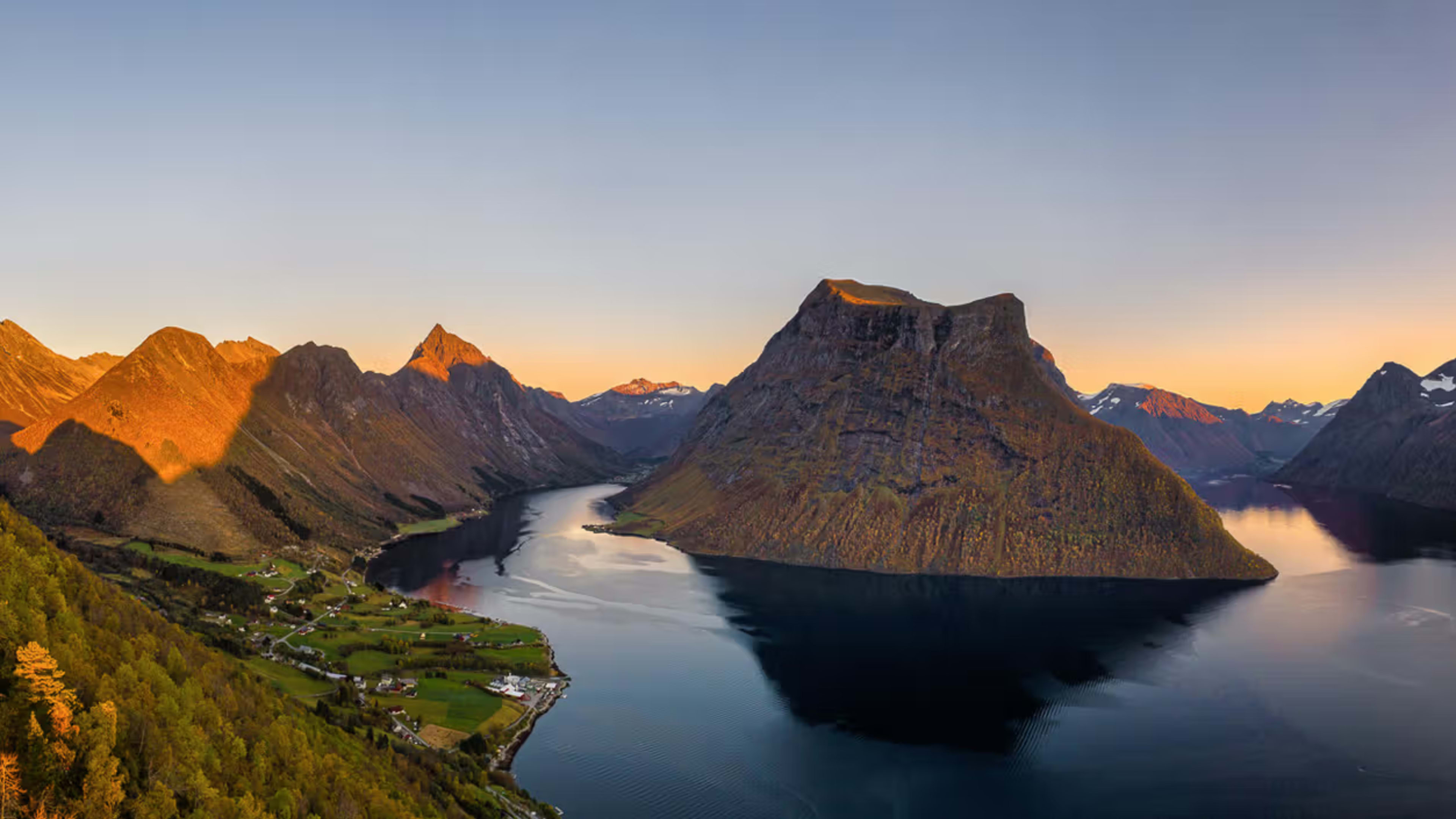Golden sunset over dramatic Norwegian fjord landscape
