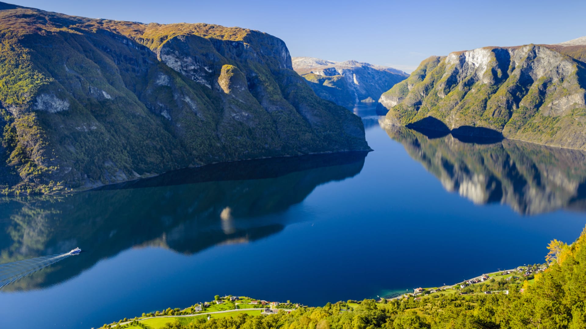 Aerial view of the Aurlandsfjord leading into the narrow Nærøyfjord with steep mountain sides and calm blue water