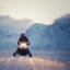 Snowmobile adventure in Lyngen Alps at sunset with pink sky and snow-covered mountains near Troms