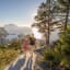 Couple climbing Aksla stairs to viewpoint overlooking Art Nouveau Ålesund and surrounding fjord islands