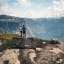 Couple on their way up to Trolltunga taking a break to enjoy the view of the surrounding landscape