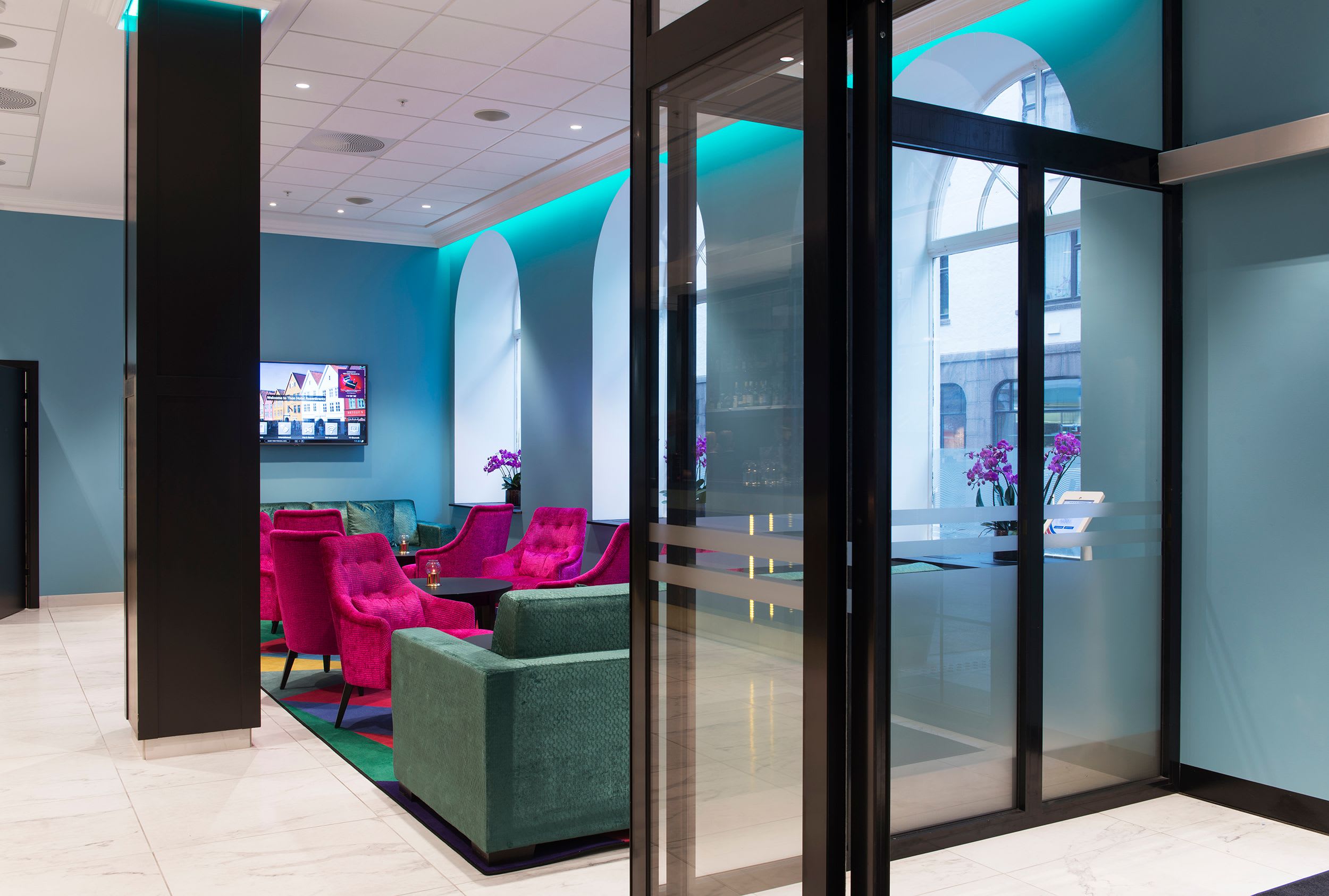 Thon Hotel Rosenkrantz Bergen lobby bar with modern colorful furniture and wall-mounted TV