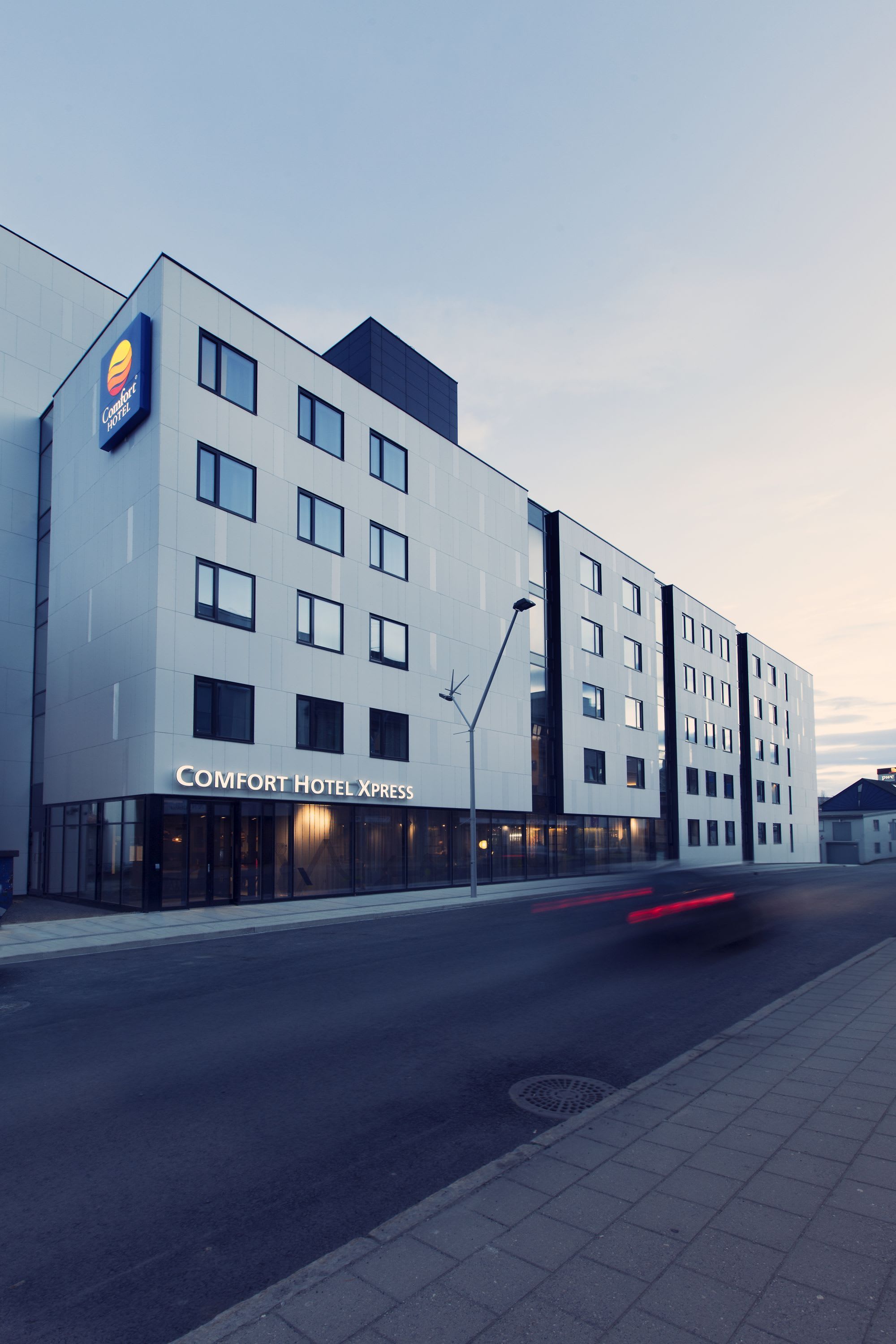 Comfort Hotel Xpress Tromsø facade with hotel sign and street access in downtown Tromsø city center