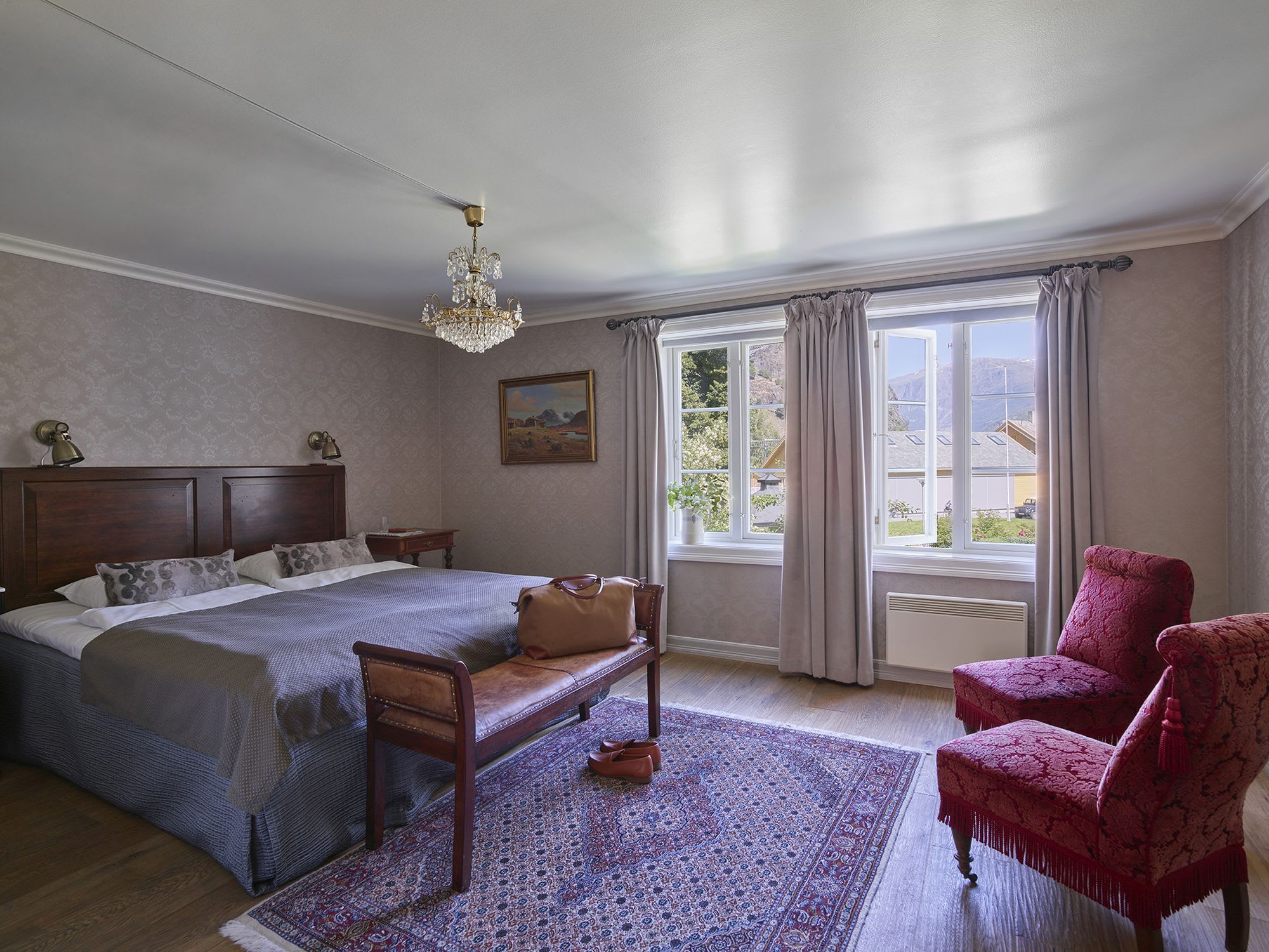 Double room at historic Fretheim Hotel Flåm with chandelier, cozy atmosphere and garden view