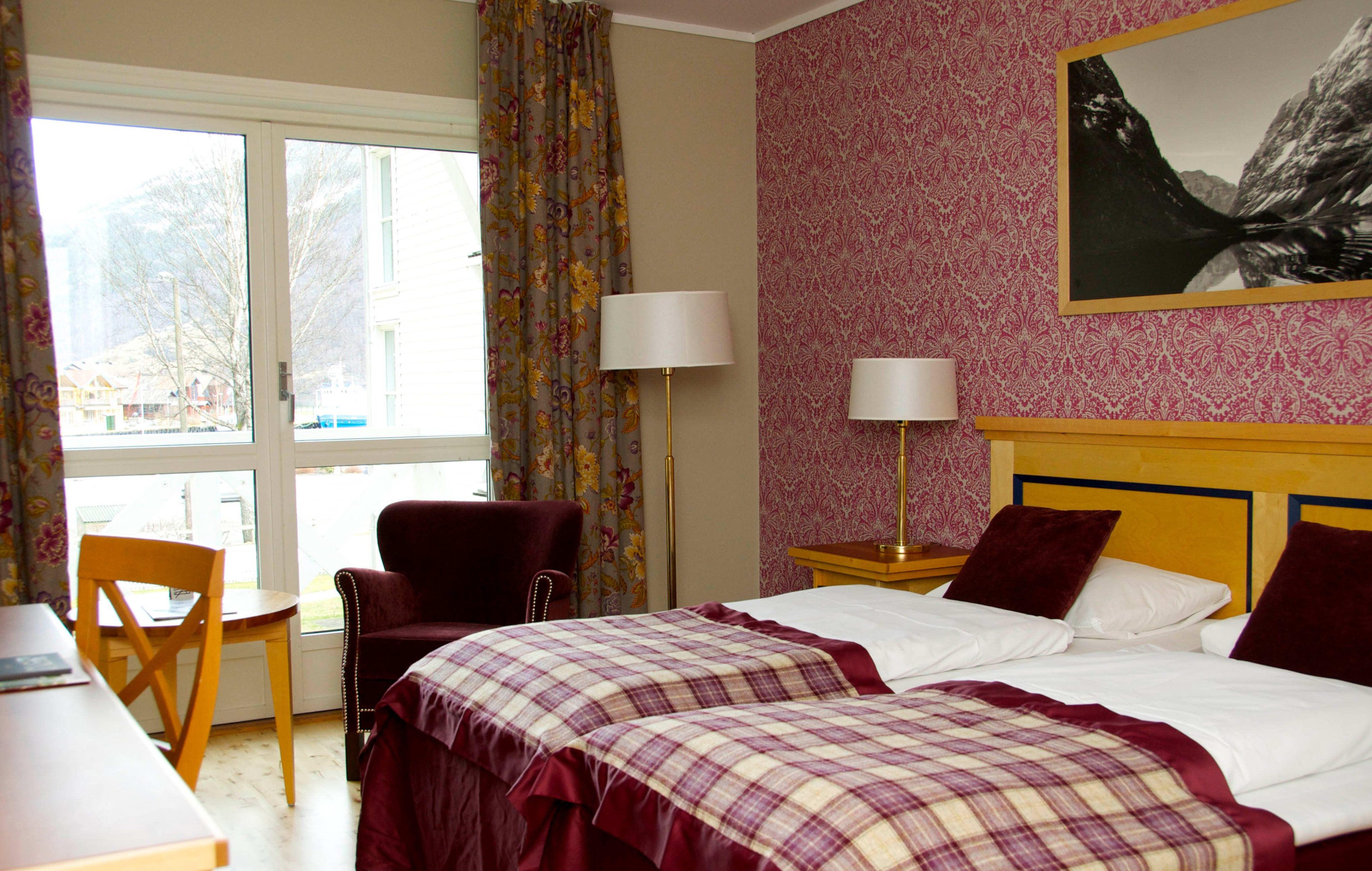 Traditional hotel room Historic Fretheim Hotel Flåm with rose wallpaper and garden views