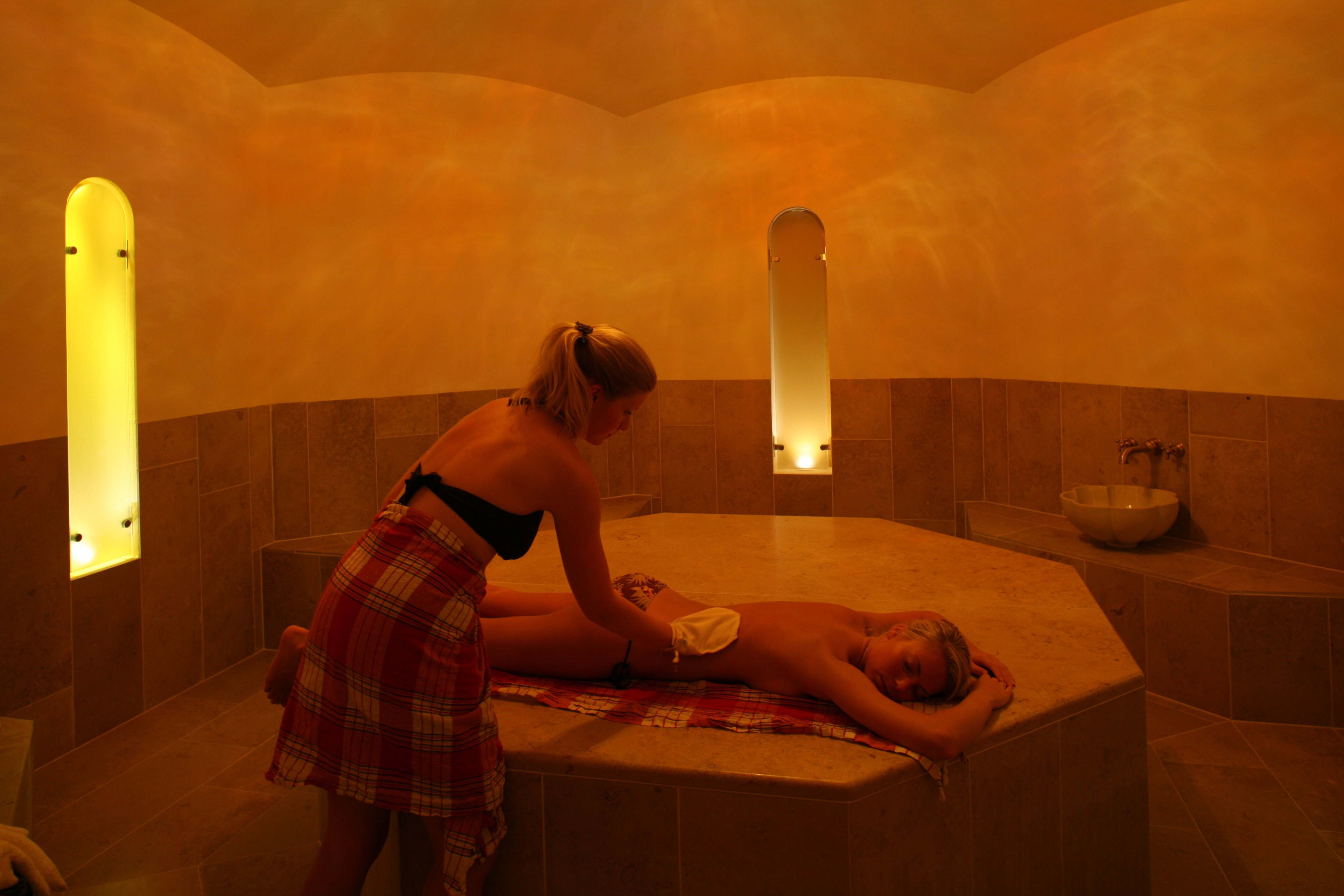 Guest enjoying peaceful spa therapy at Hotel Union Geiranger featuring soft lighting and elegant wellness decor