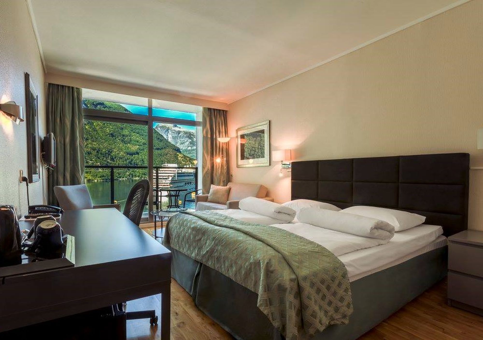 Elegant double room Havila Hotel Geiranger with private balcony overlooking UNESCO Geirangerfjord