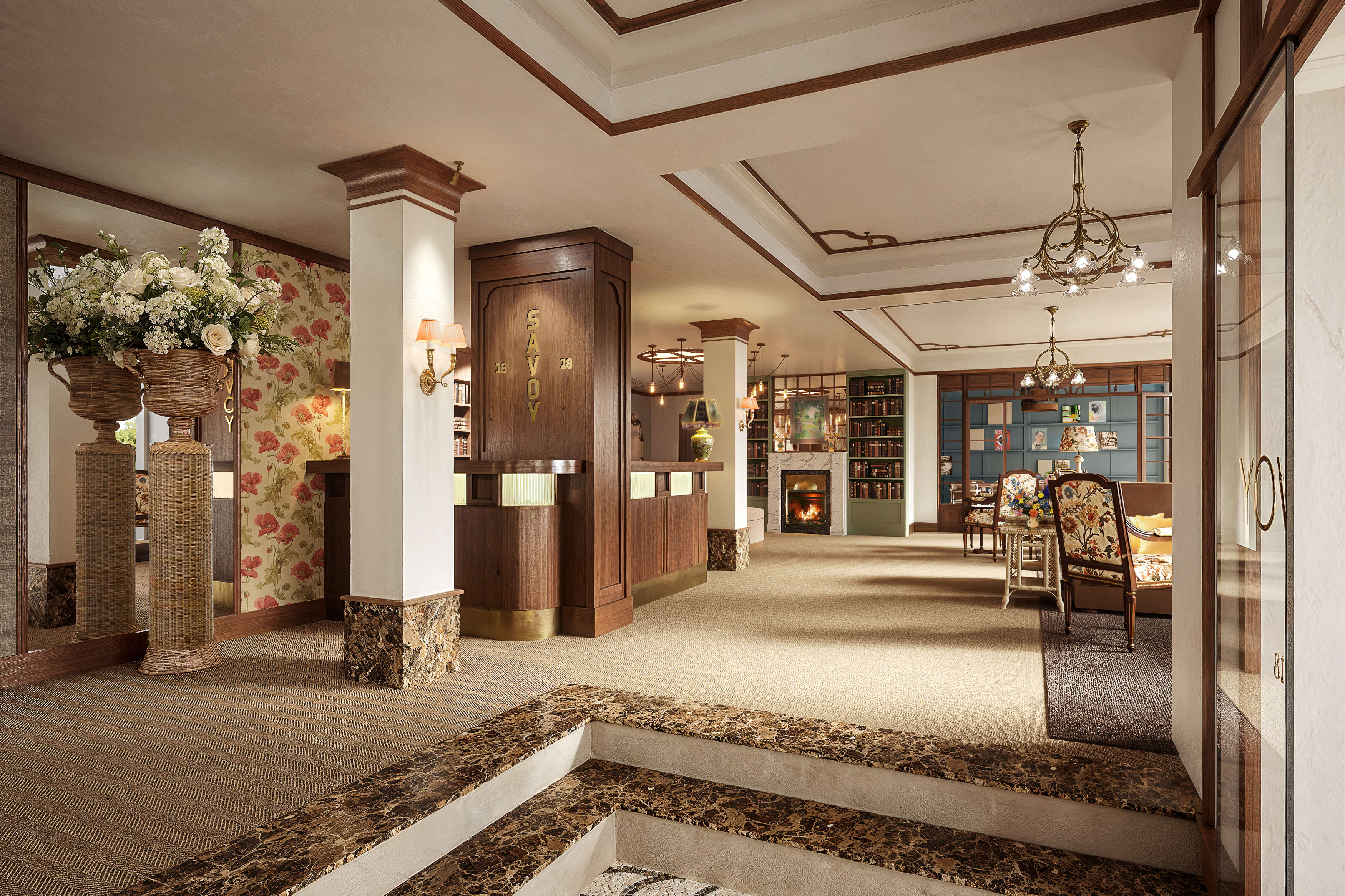 Savoy 1918 Oslo hotel lobby with elegant chandeliers and beige and white interior design