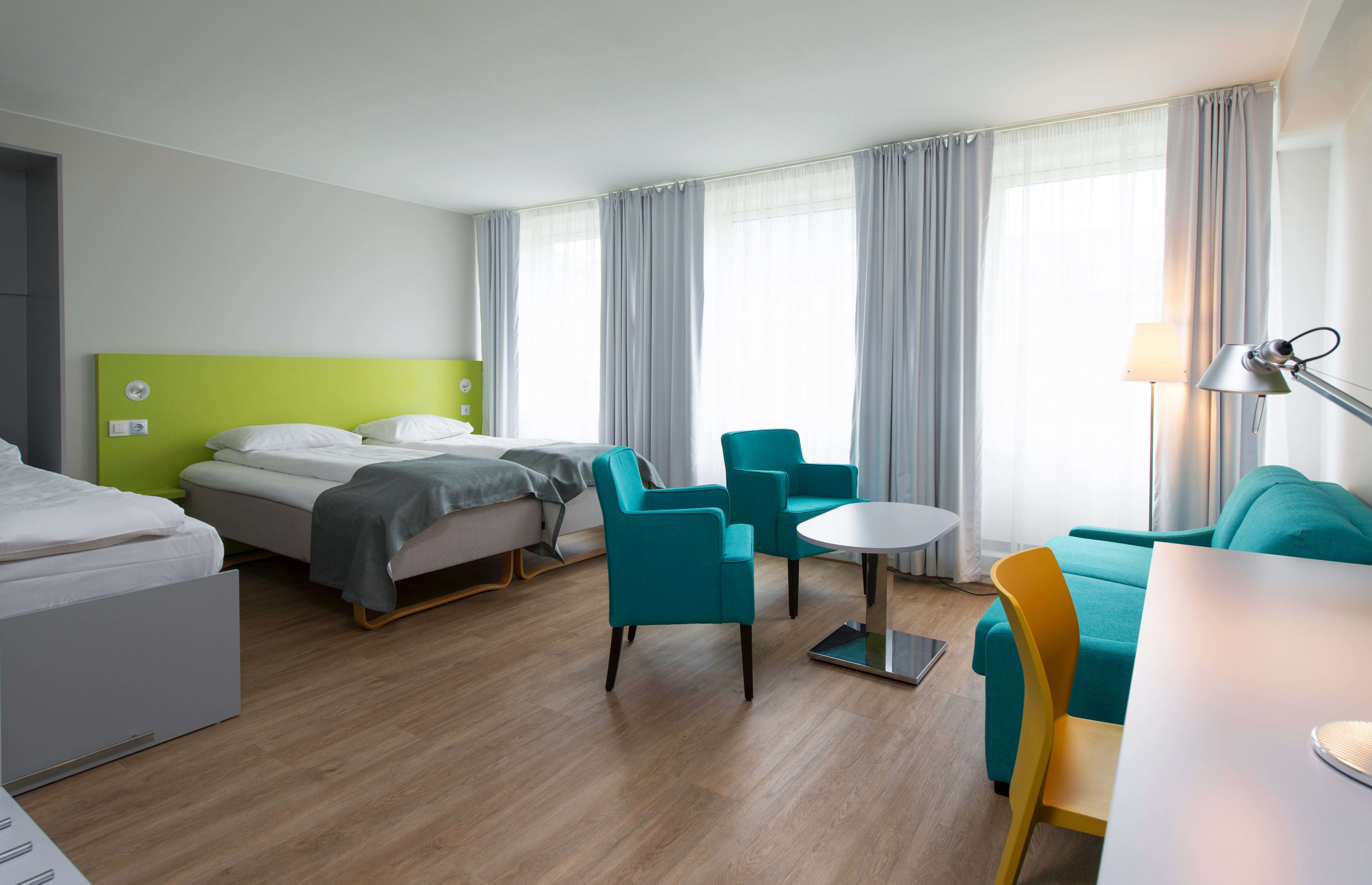 Thon Hotel Trondheim colorful triple room with sofa corner, bright walls and comfortable accommodation for families in Trondheim