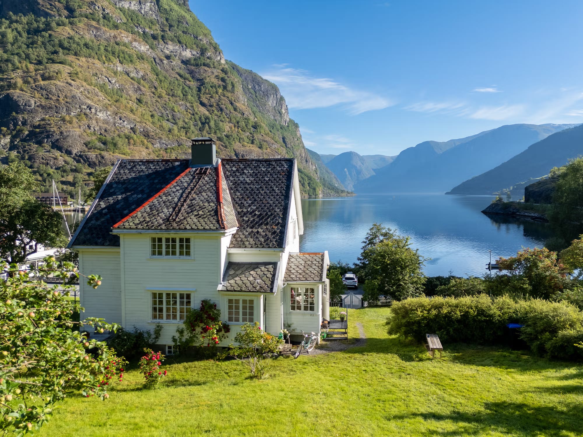 Traditional white Norwegian farmhouse in Flåm fjord valley
