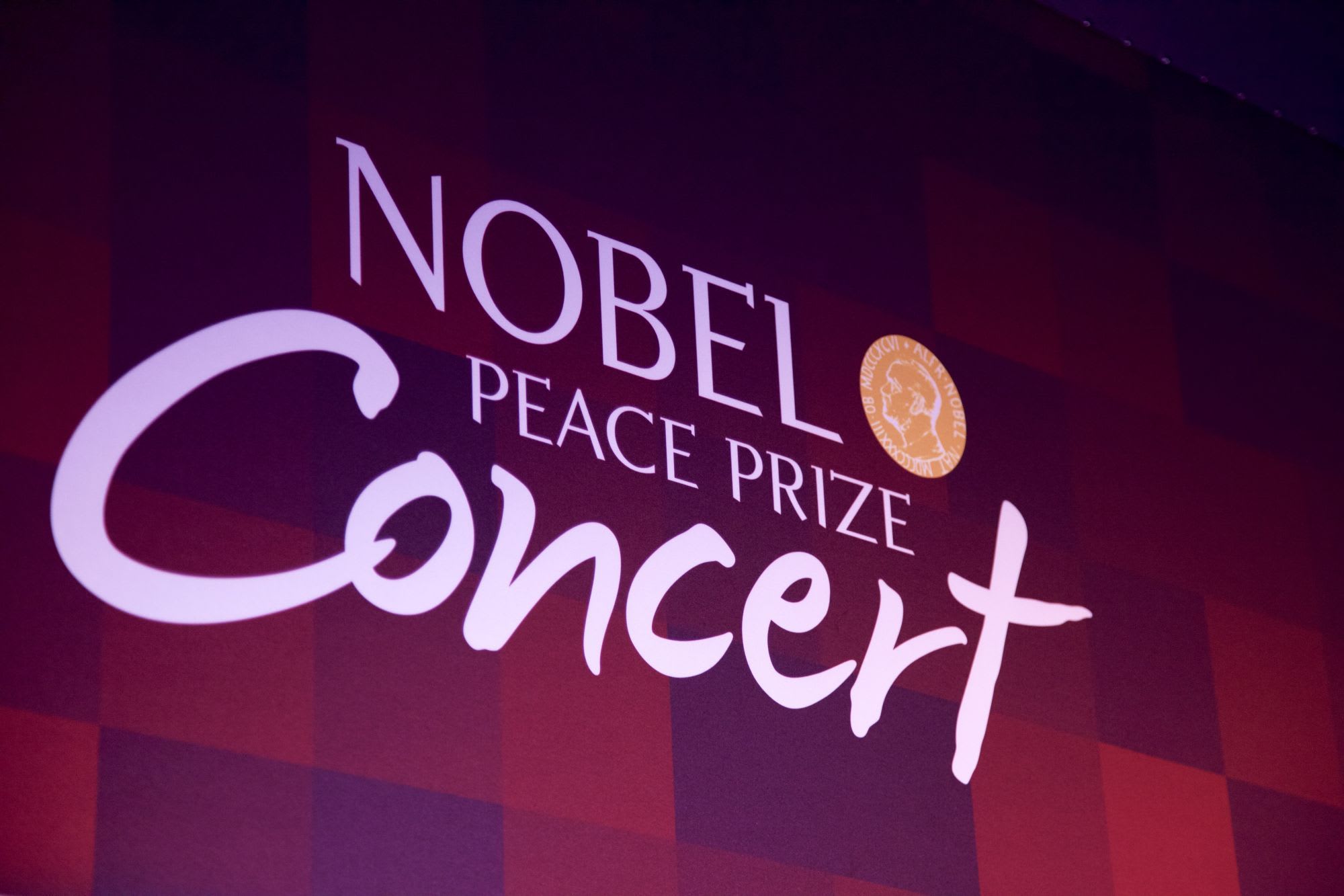 Close-up of "Nobel Peace Prize Concert" banner with bold text and Nobel Prize emblem, highlighting prestigious event.