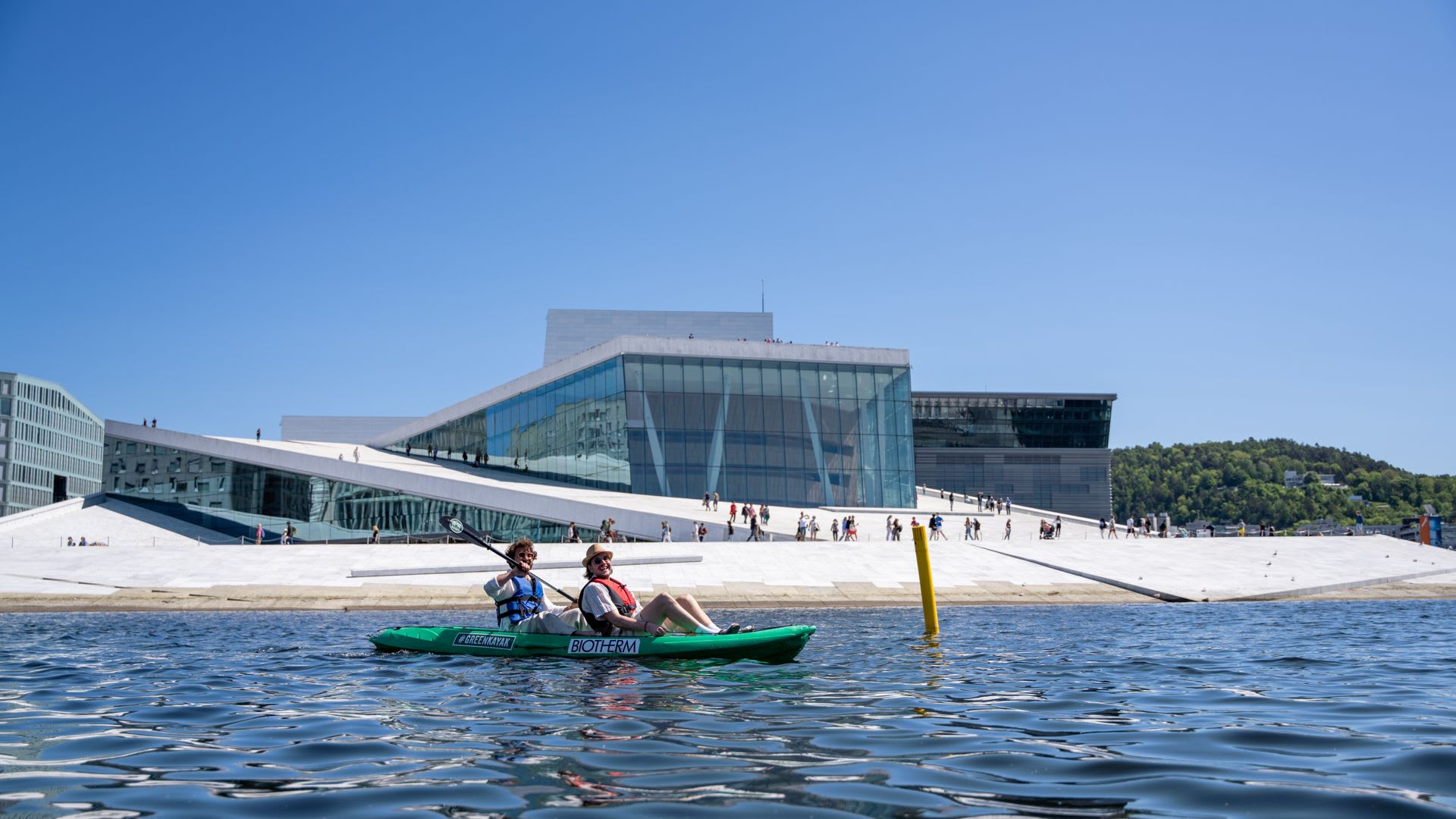 Kayaking tour in Oslo fjord with Opera House architecture on sunny day - guided water activity Norway