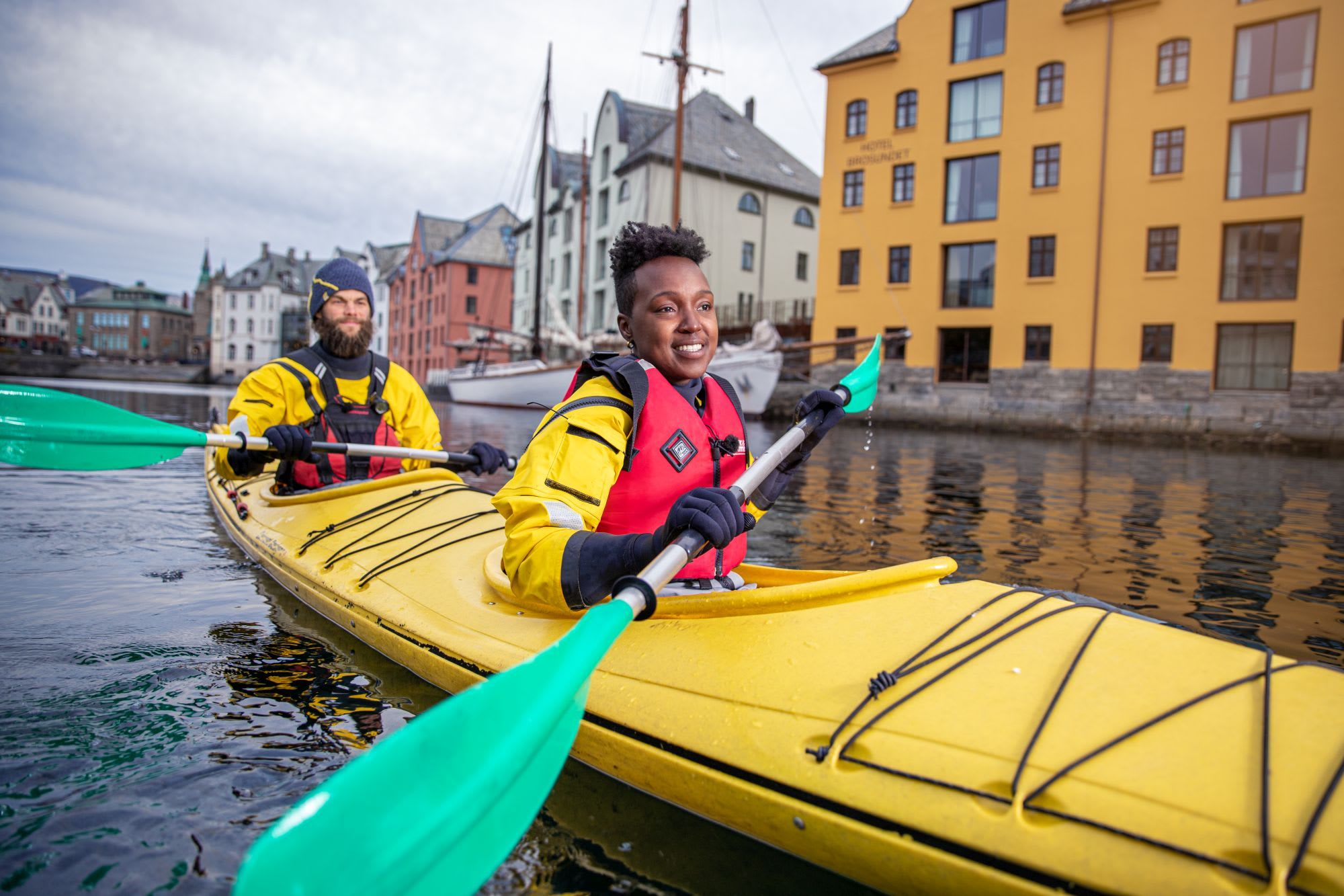 Winter kayaking in Ålesund with view of historic Art Nouveau buildings along Brosundet canal