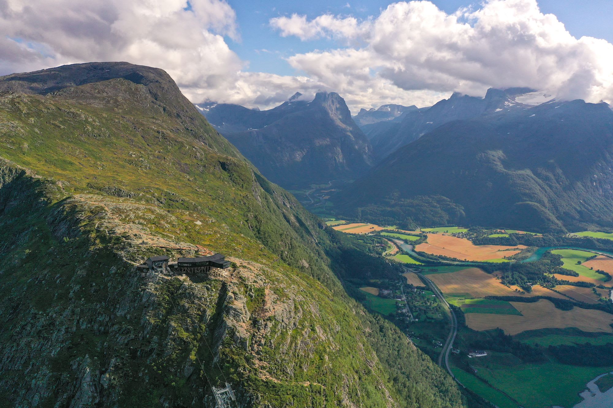 Landscape with mountains, valley, and river, with the Eggen Restaurant at the top.