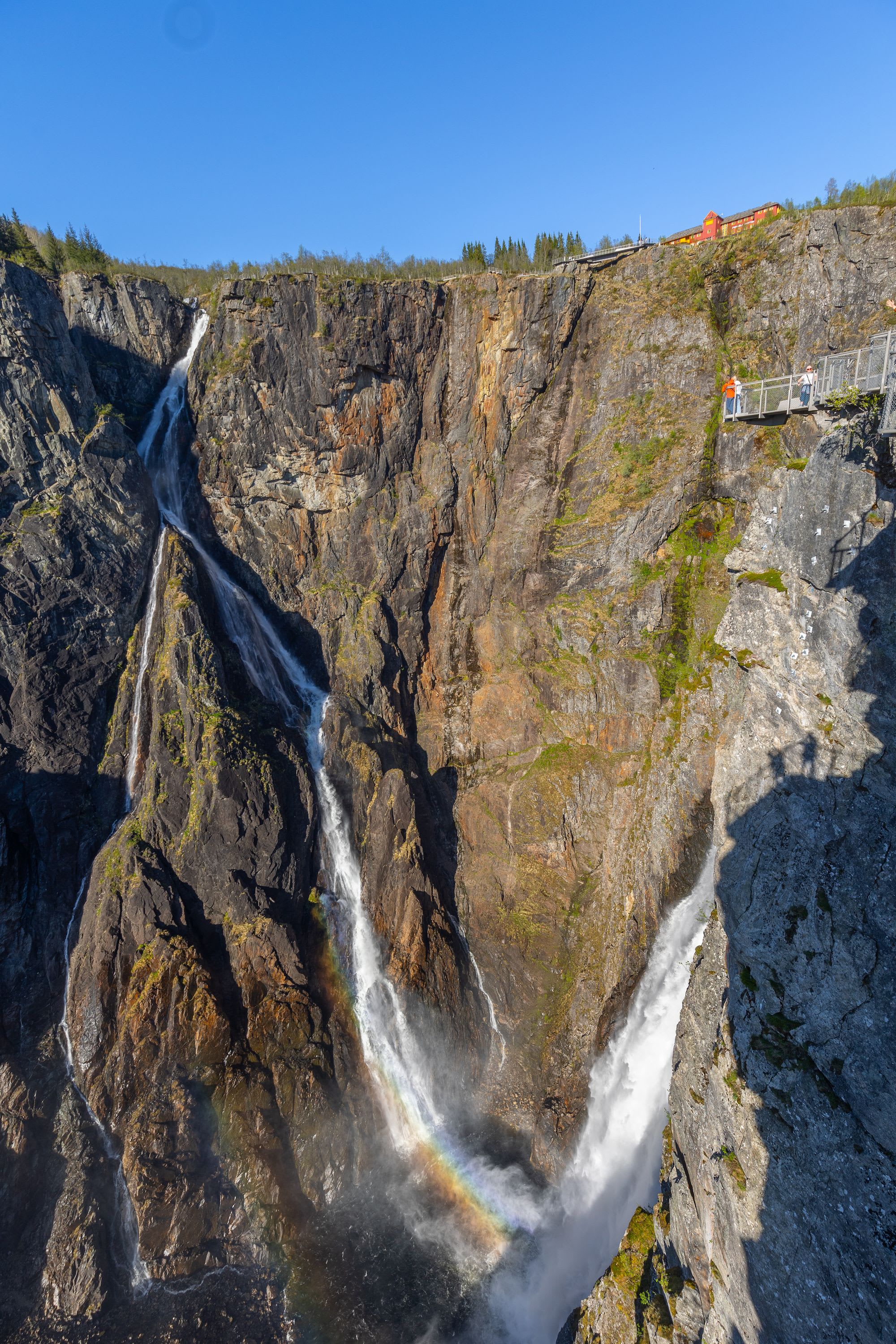 Catch the magical rainbow that appears in Vøringsfossen's mist - see this natural wonder from above as the water crashes down creating nature's perfect moment