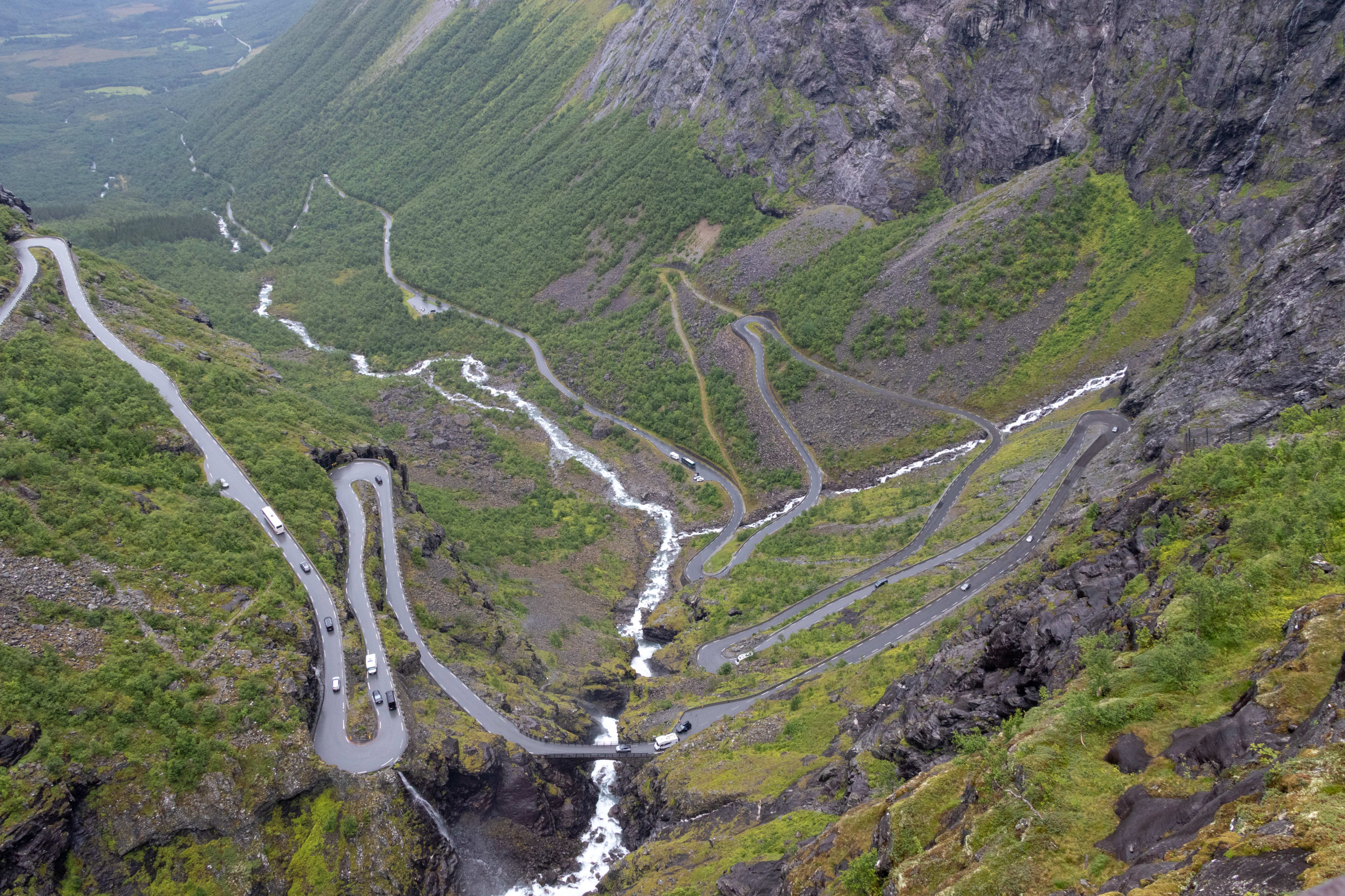 Nærbilde av hårnålssvingene i Trollstigen, med Stigfossen som renner gjennom fjellveien