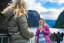 Travellers enjoying a fjord cruise viewpoint with mountains and the Nærøyfjord in the background.