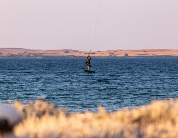 Kitesurfing with a foil board at Aliki beach, Limnos