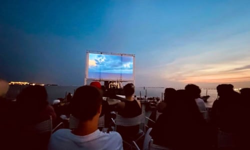 The floating cinema - people watching a film on a deck in the middle of the water.