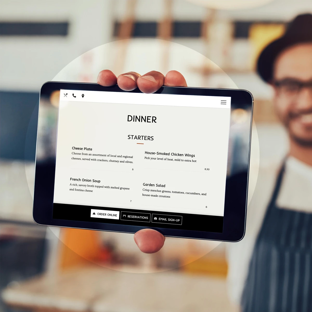 person holding a restaurant website menu on a small tablet