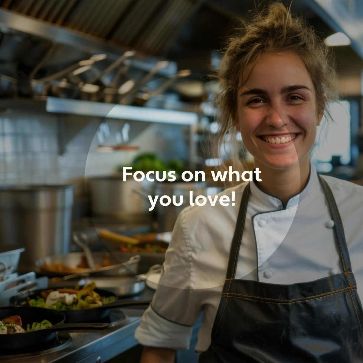 woman chef in a busy kitchen with a smile