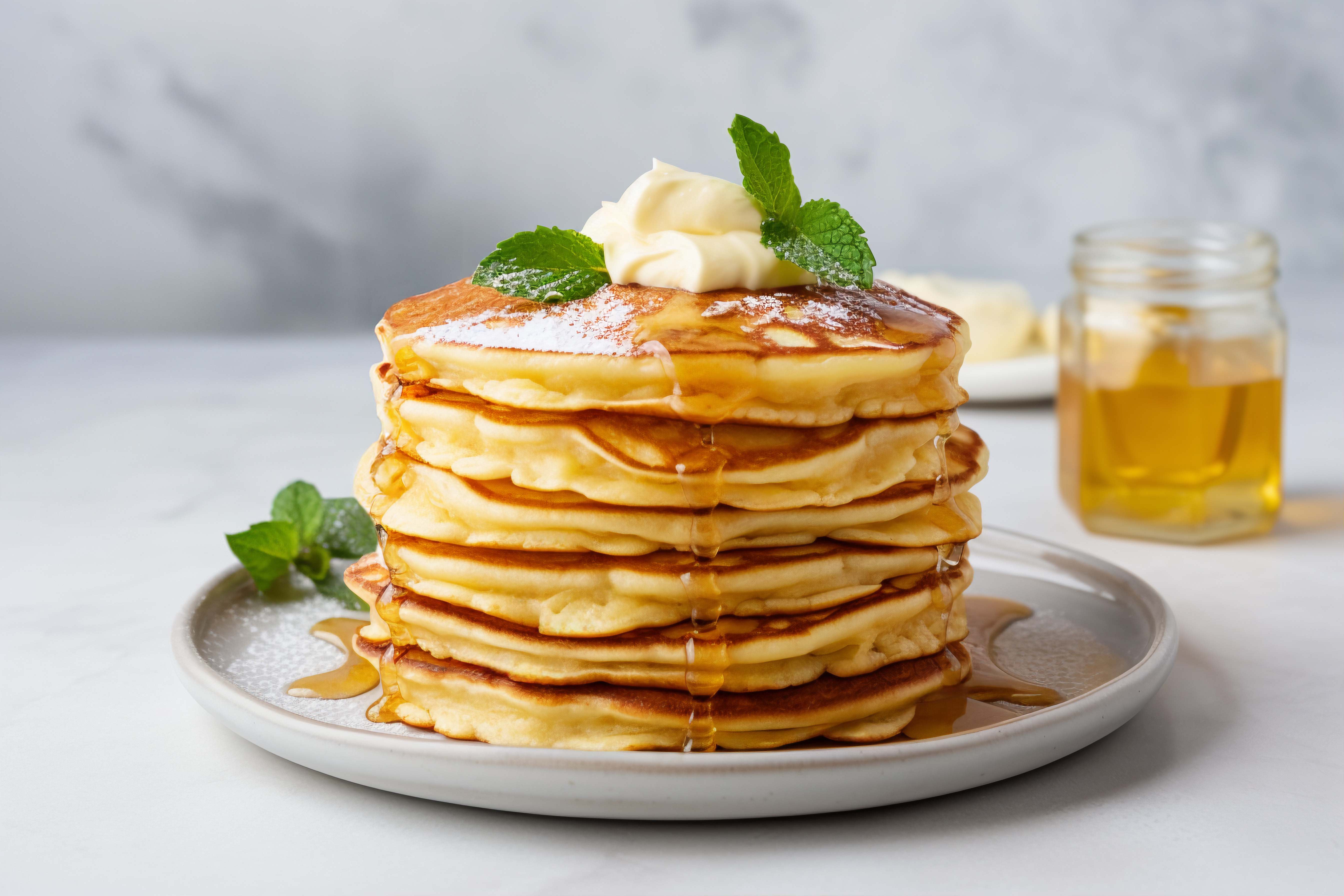 Stack of fluffy pancakes with syrup
