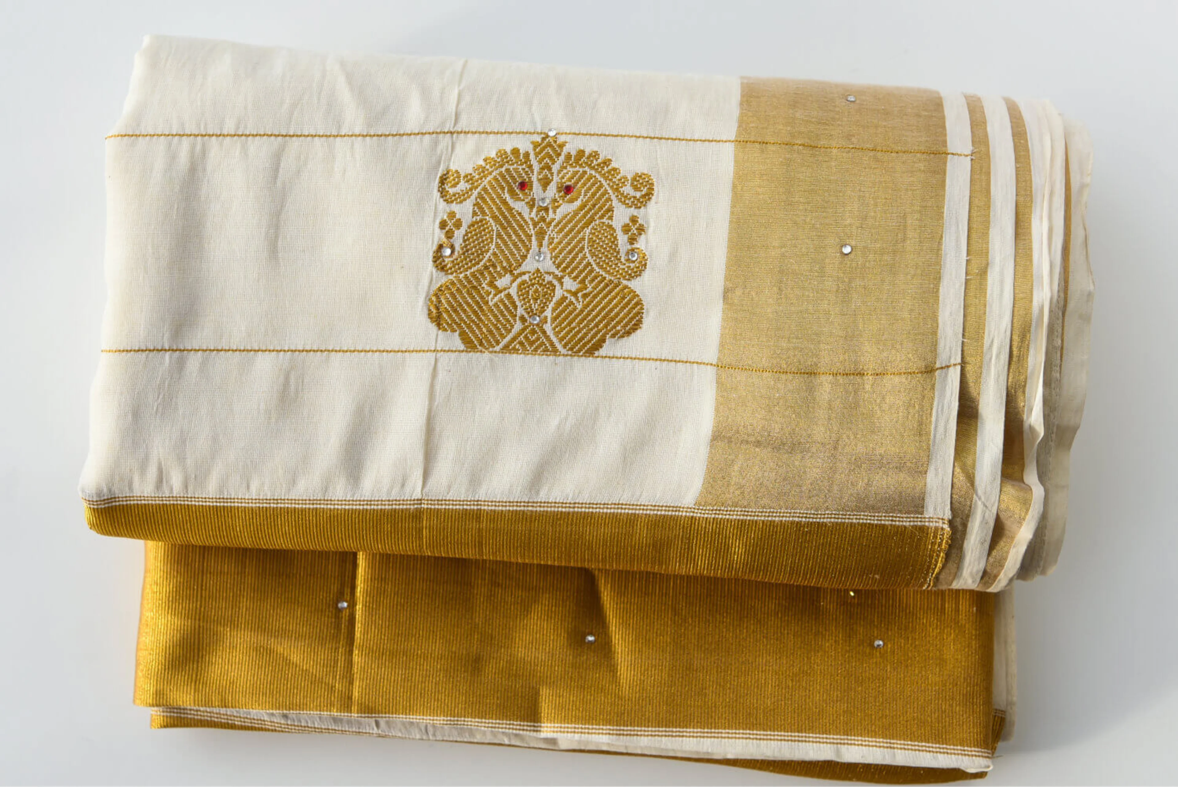 A handmade white and yellow Indian silk sari, folded