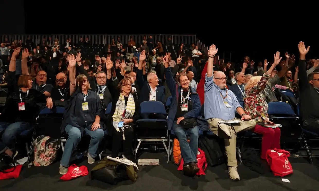 A scene from the Labour conference. Party members raise their hands, backing a motion calling on the party to adopt a proportional electoral system.