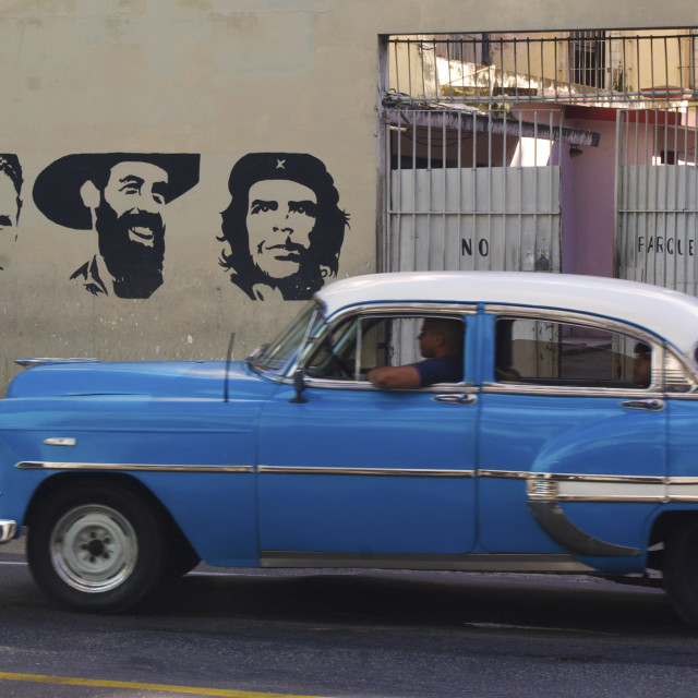 "Vintage car in front of mural" stock image