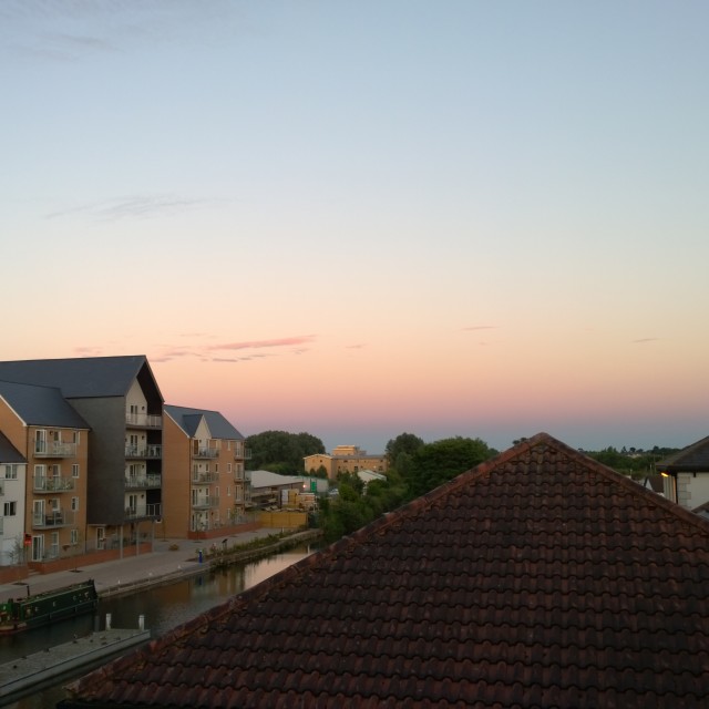 "Beautiful sunset over a canal and rooftops" stock image