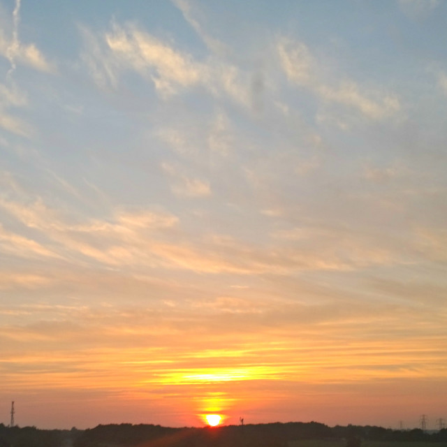 "Wispy clouded sunset" stock image