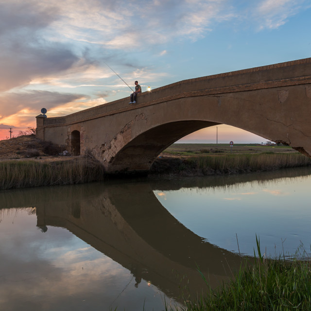 "Man fishing in river" stock image